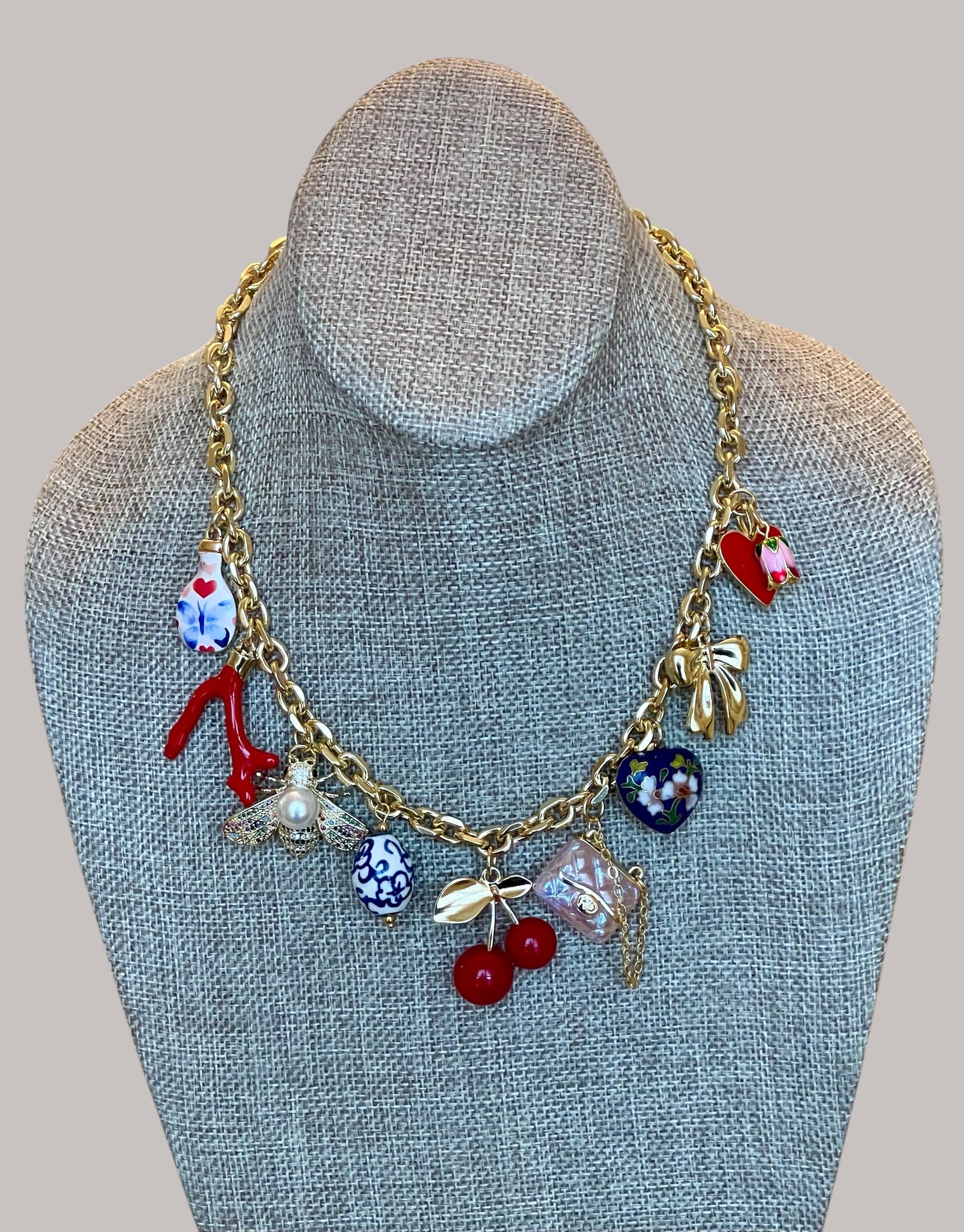 The Jackie Necklace: Tarnish resistant gold chain with various charms in a red pink & blue theme