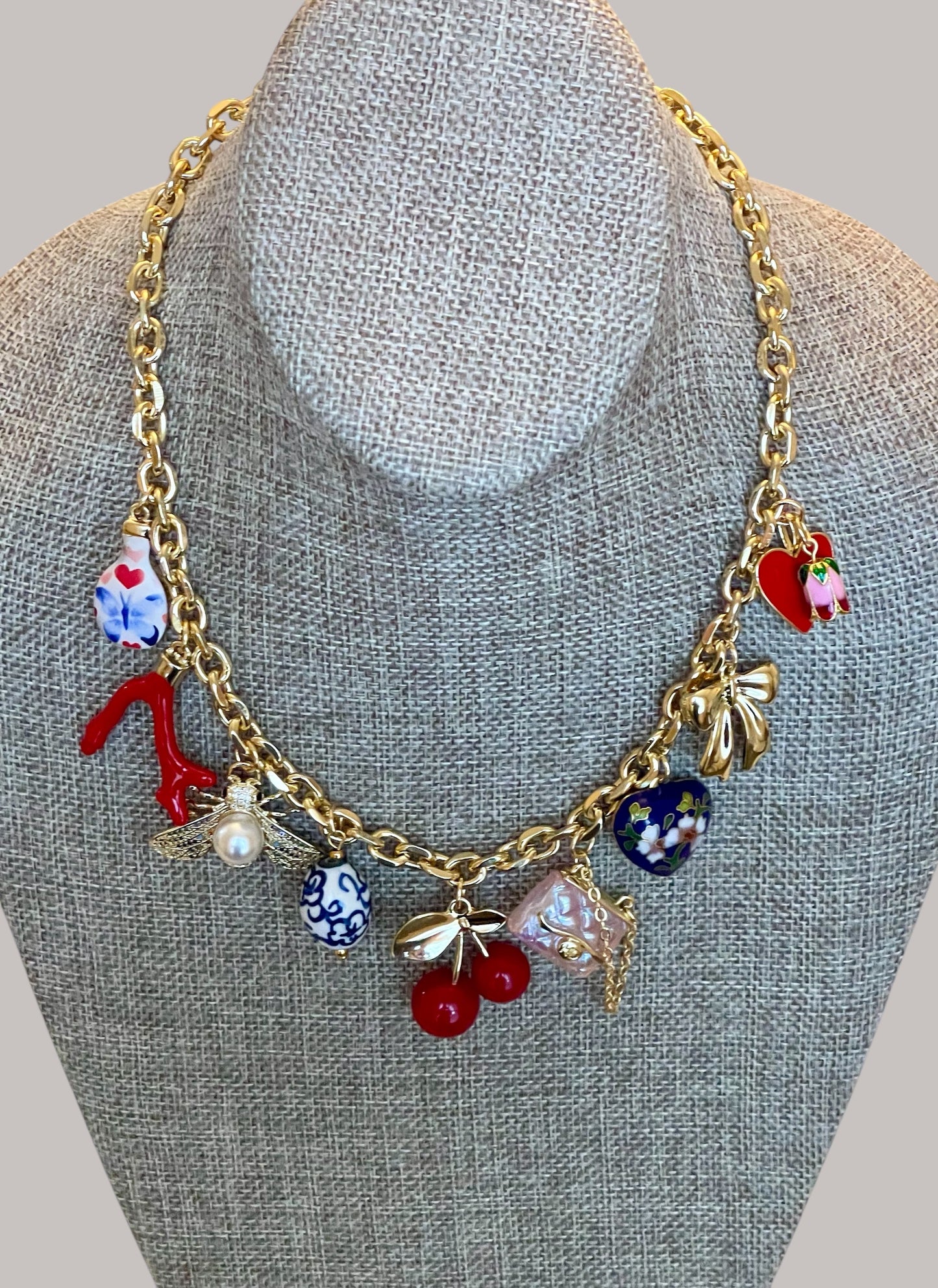 The Jackie Necklace: Tarnish resistant gold chain with various charms in a red pink & blue theme