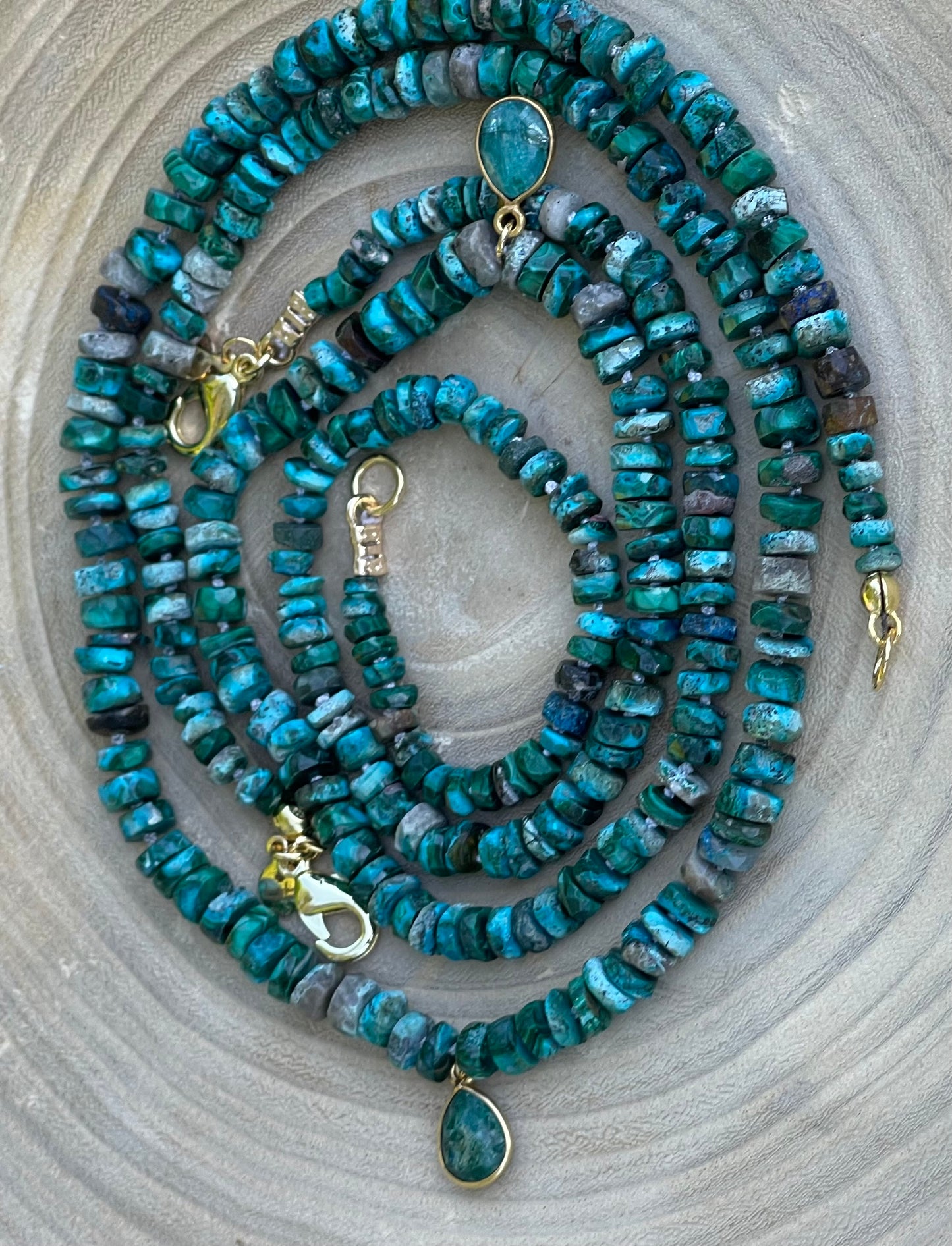 Tibetan Tides Necklace: Faceted Tibetan Turquoise Handknotted on silk with an Emerald teardrop pendant