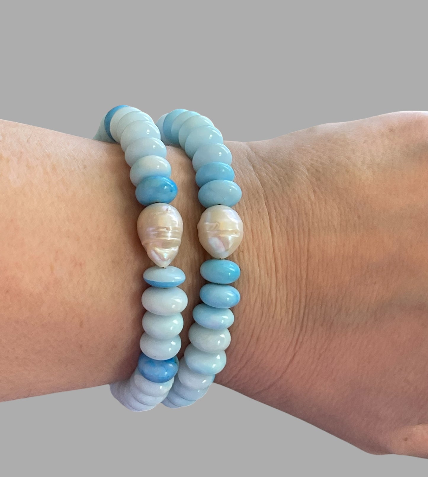 Robin’s Egg Opal Bracelet: Robin’s egg blue Opals with a Baroque Pearl center Gold clasp