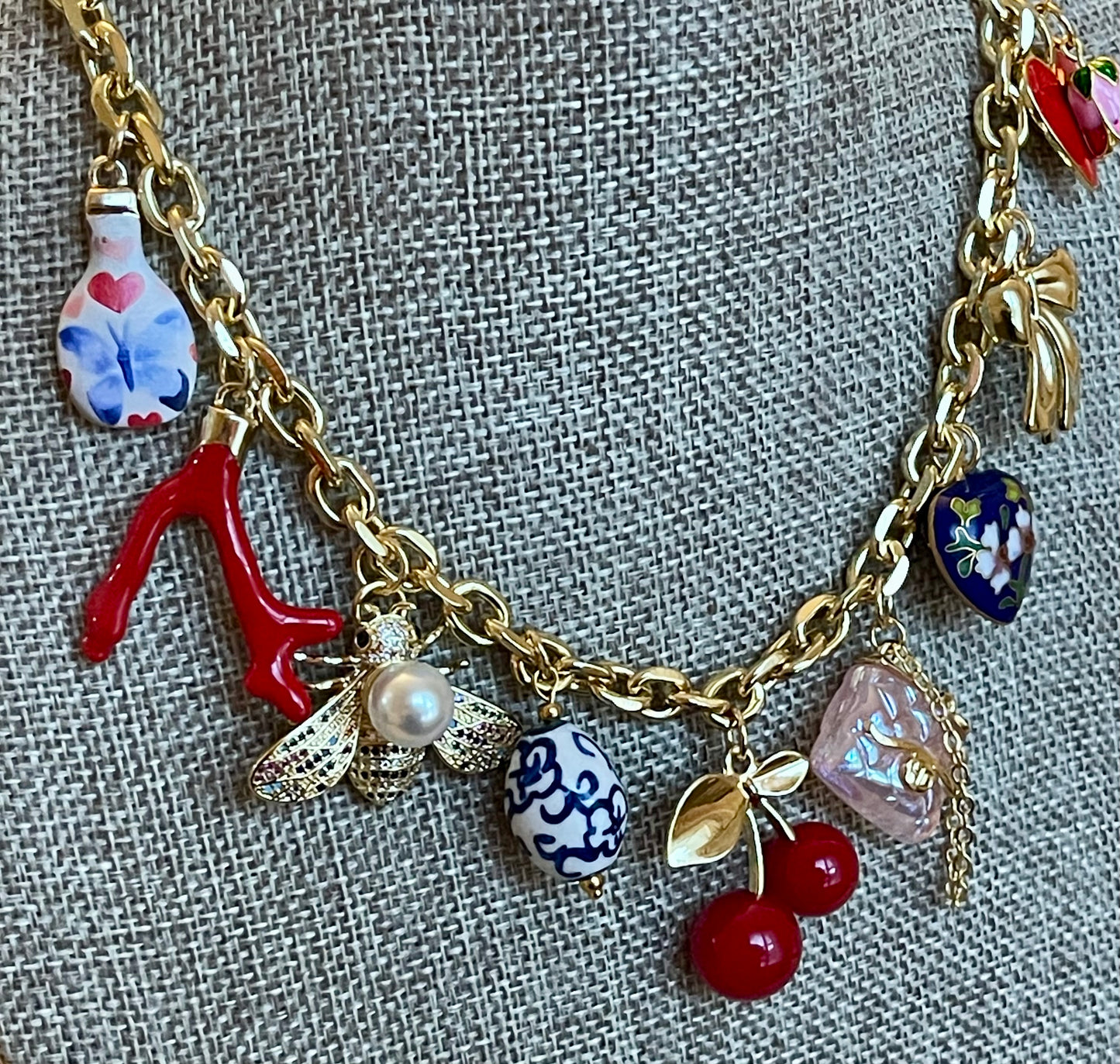 The Jackie Necklace: Tarnish resistant gold chain with various charms in a red pink & blue theme