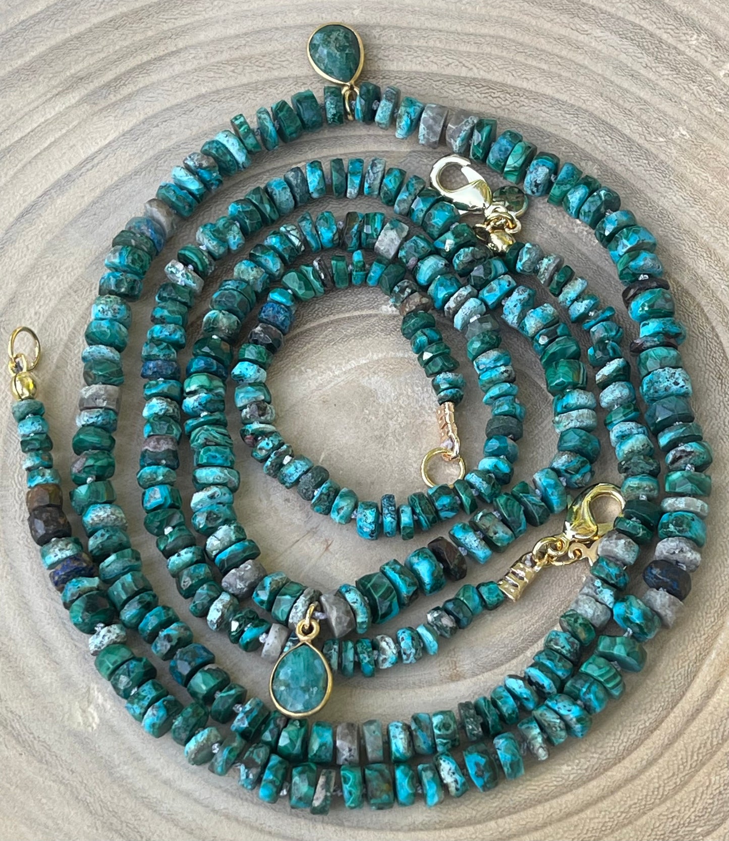 Tibetan Tides Necklace: Faceted Tibetan Turquoise Handknotted on silk with an Emerald teardrop pendant