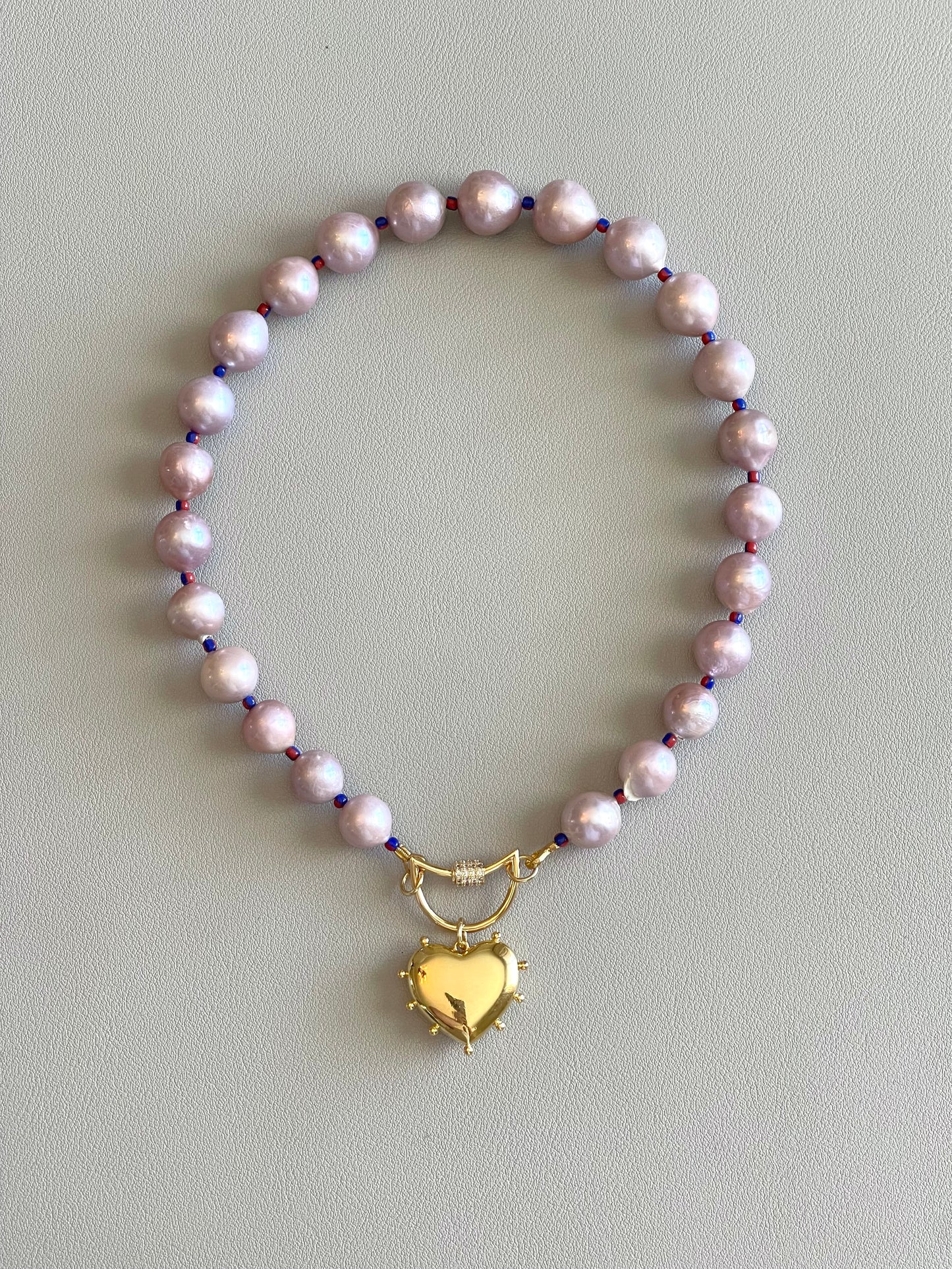 The Yves Necklace: Lavender Edison Pearls w/glass spacers, a gold crescent clasp holding a heart pendant OOAK