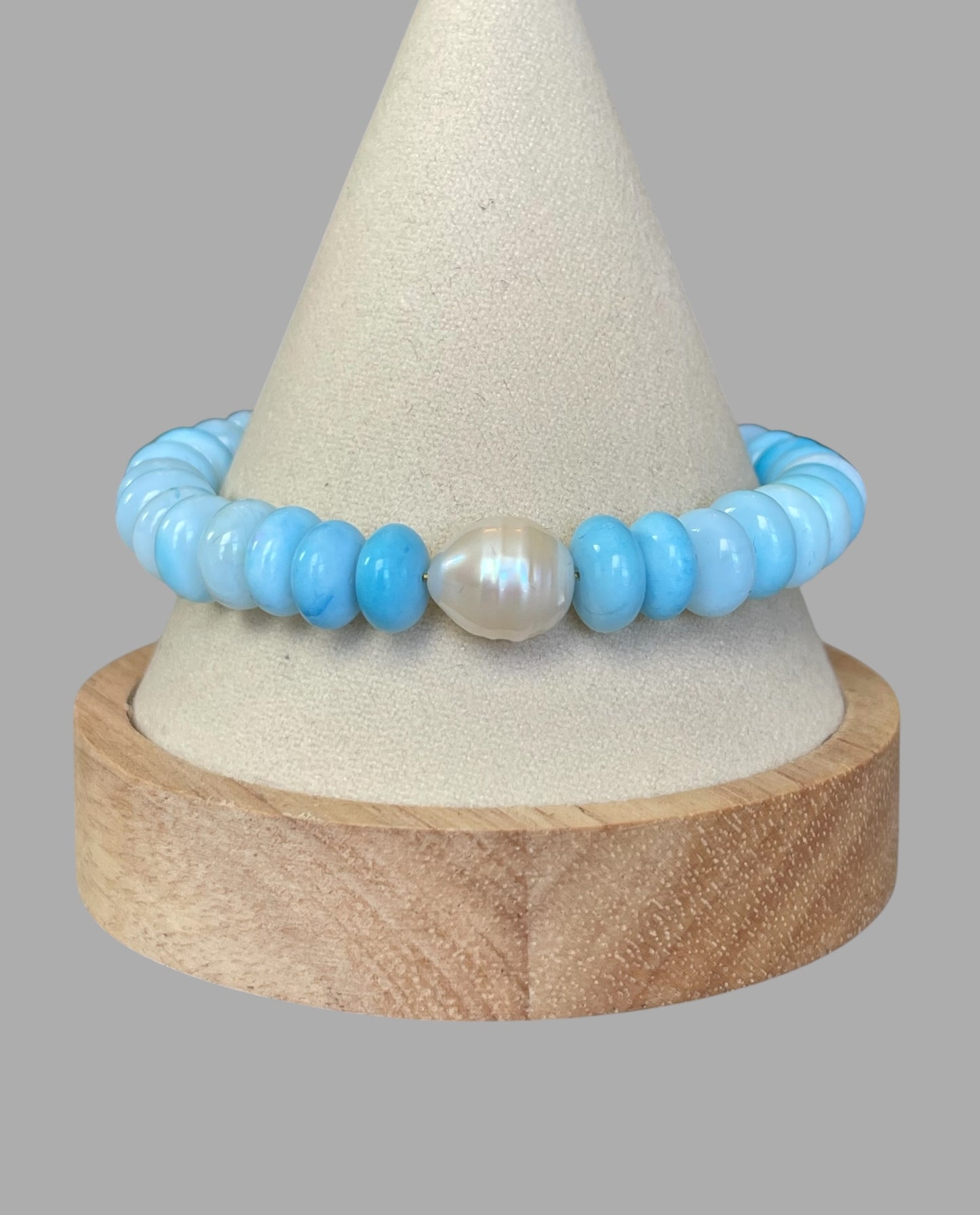 Robin’s Egg Opal Bracelet: Robin’s egg blue Opals with a Baroque Pearl center Gold clasp
