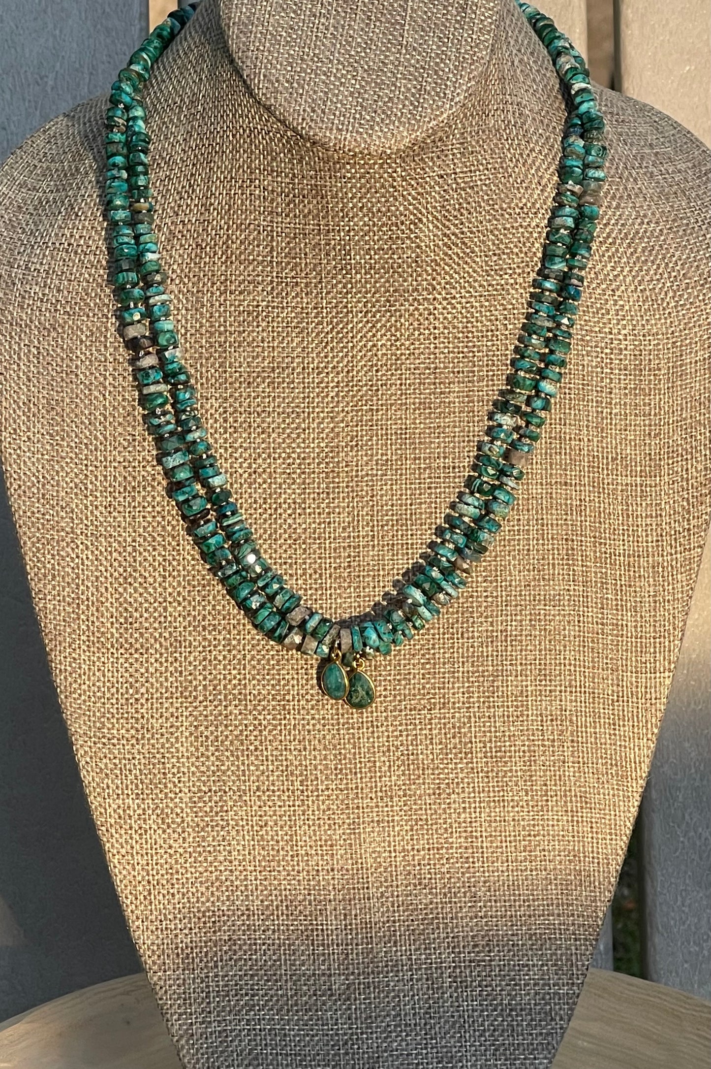 Tibetan Tides Necklace: Faceted Tibetan Turquoise Handknotted on silk with an Emerald teardrop pendant