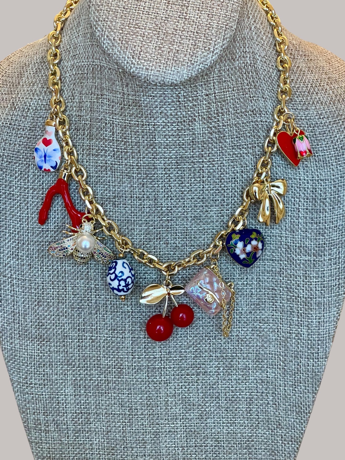 The Jackie Necklace: Tarnish resistant gold chain with various charms in a red pink & blue theme