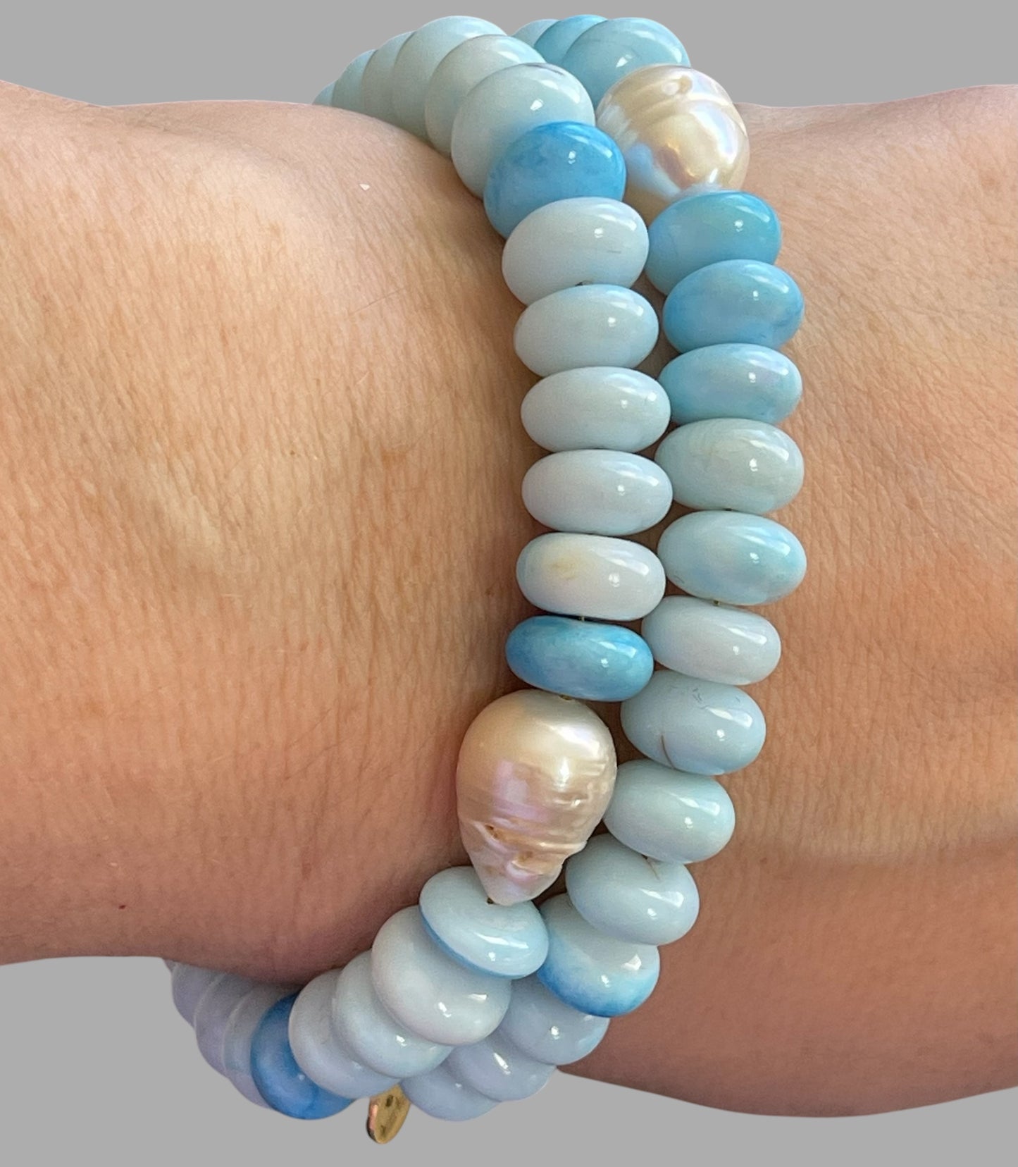 Robin’s Egg Opal Bracelet: Robin’s egg blue Opals with a Baroque Pearl center Gold clasp