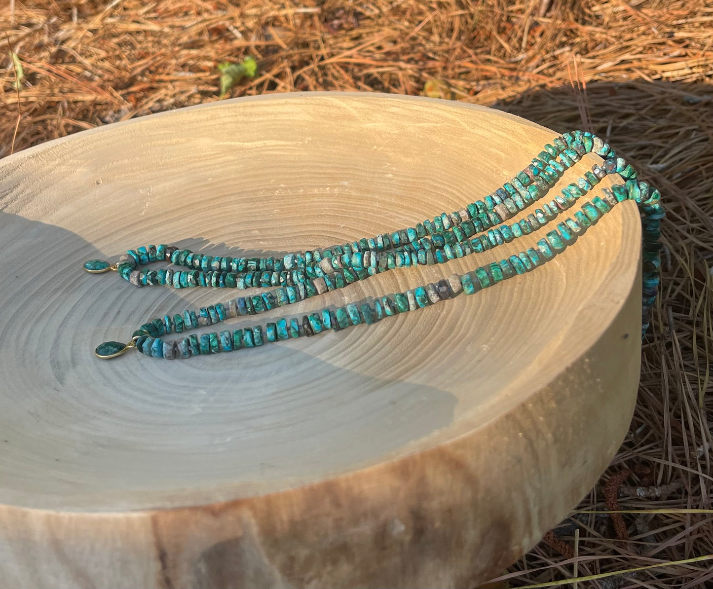 Tibetan Tides Necklace: Faceted Tibetan Turquoise Handknotted on silk with an Emerald teardrop pendant