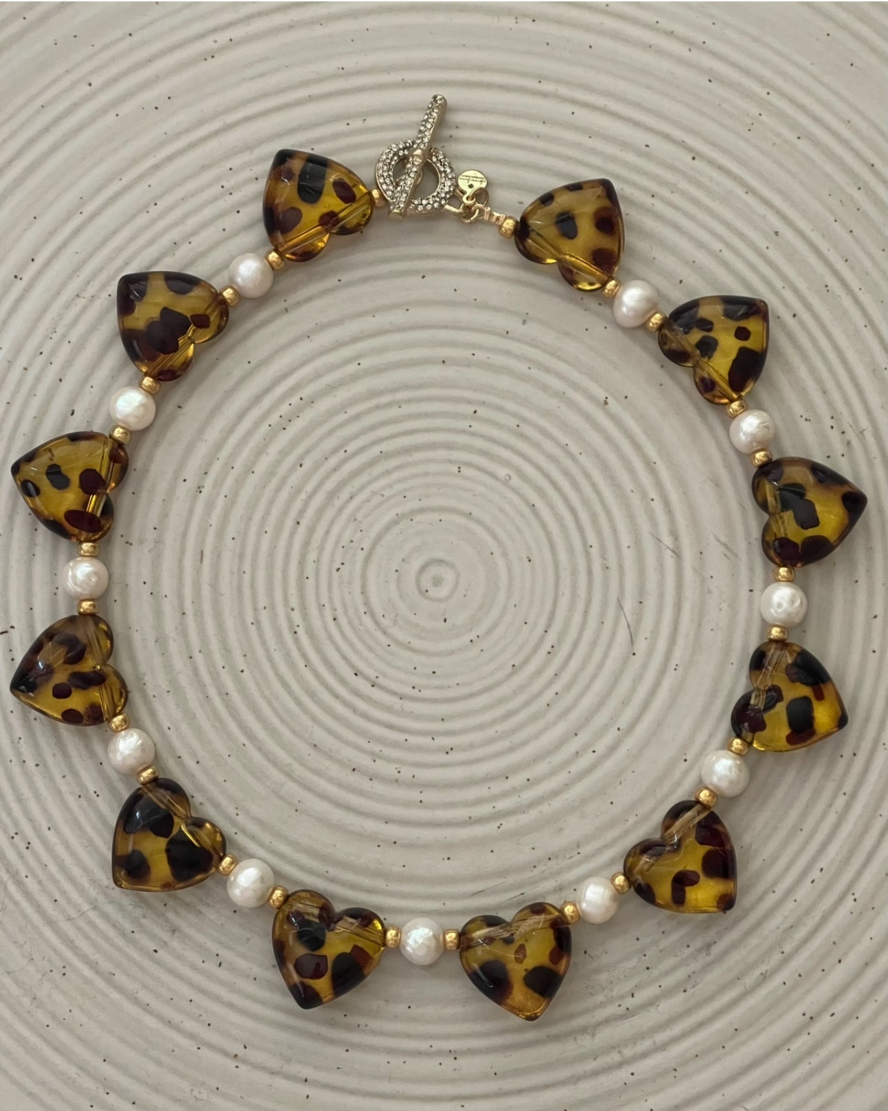 Leopard Love Necklace: Acrylic Leopard Print hearts with gold glass accent beads and Freshwater Pearls Gold Pavé toggle clasp