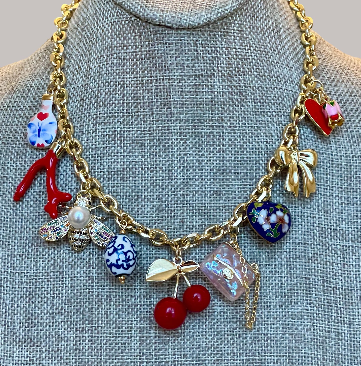The Jackie Necklace: Tarnish resistant gold chain with various charms in a red pink & blue theme
