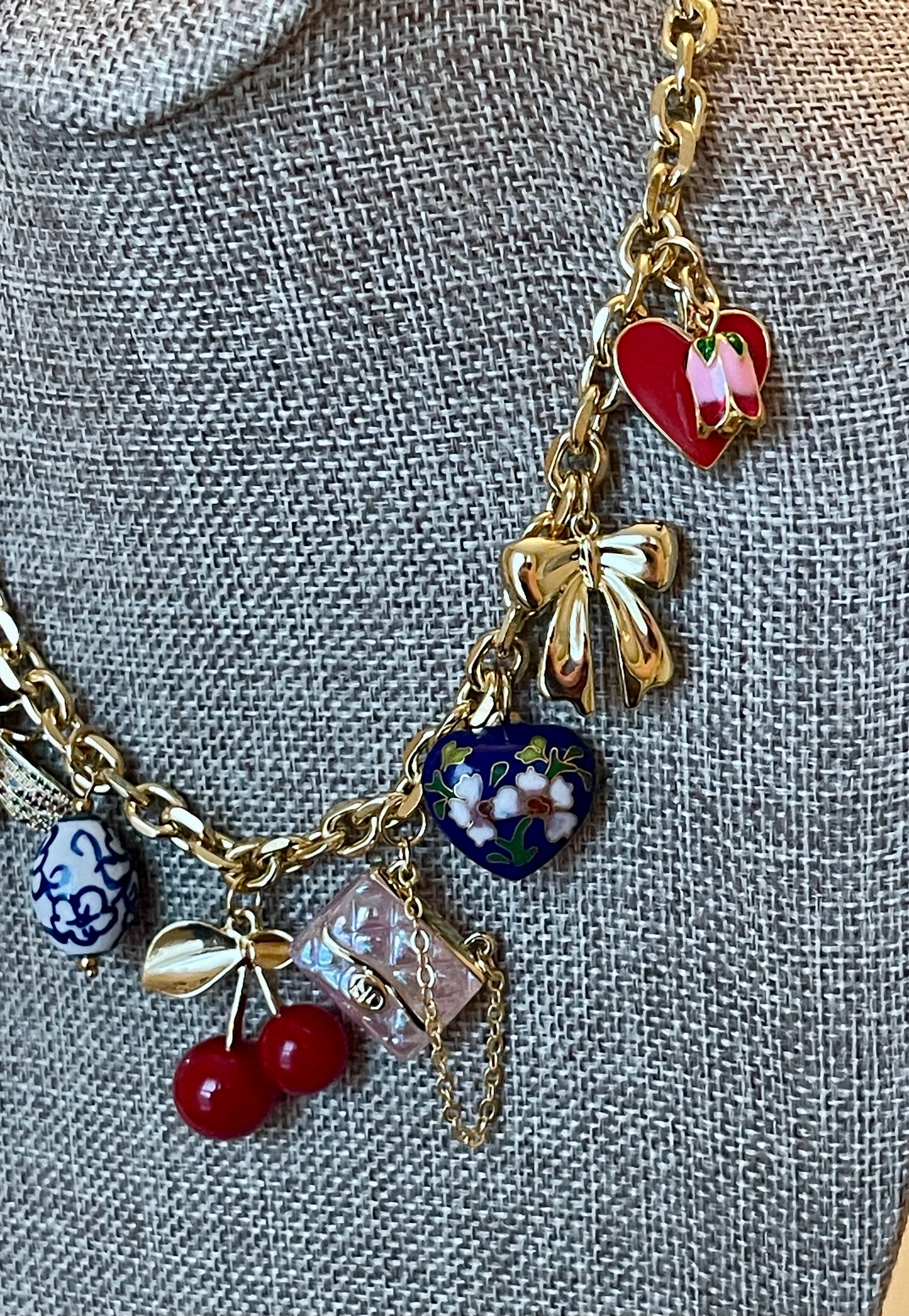 The Jackie Necklace: Tarnish resistant gold chain with various charms in a red pink & blue theme