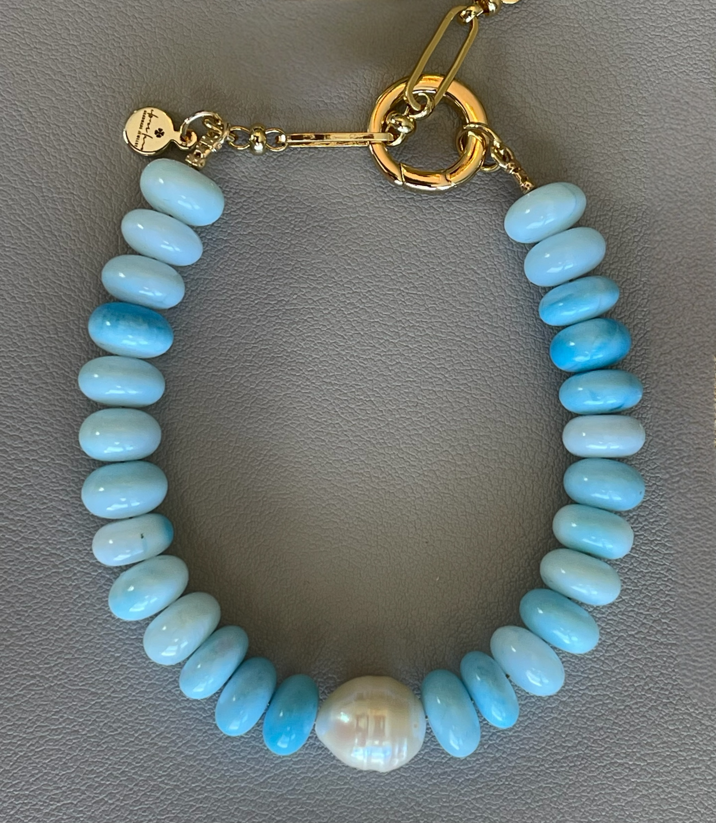 Robin’s Egg Opal Bracelet: Robin’s egg blue Opals with a Baroque Pearl center Gold clasp