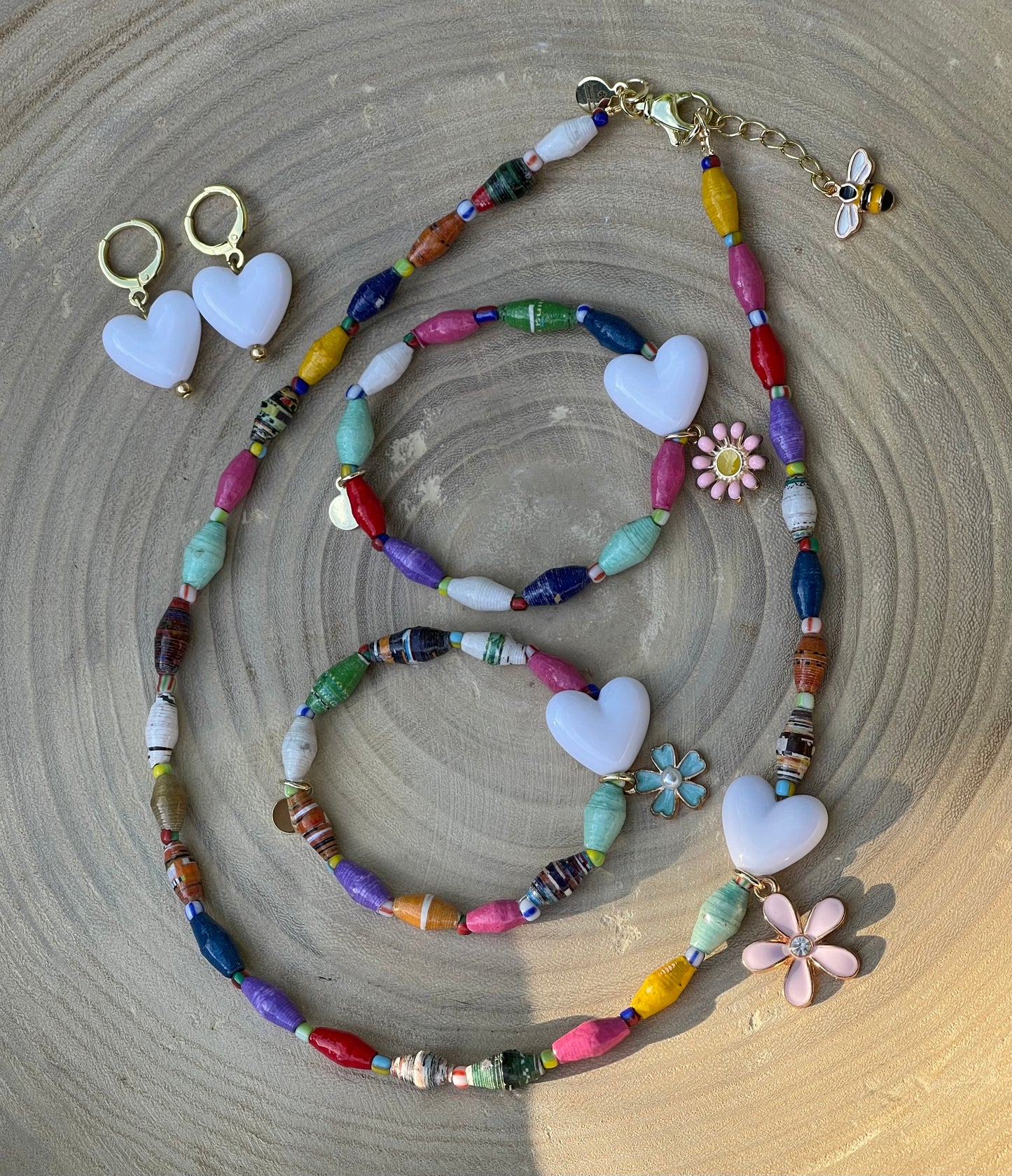 Kindred Colors Bracelet: Recycled paper bicone shaped beads, glass spacer beads, shiny white heart and flower charm