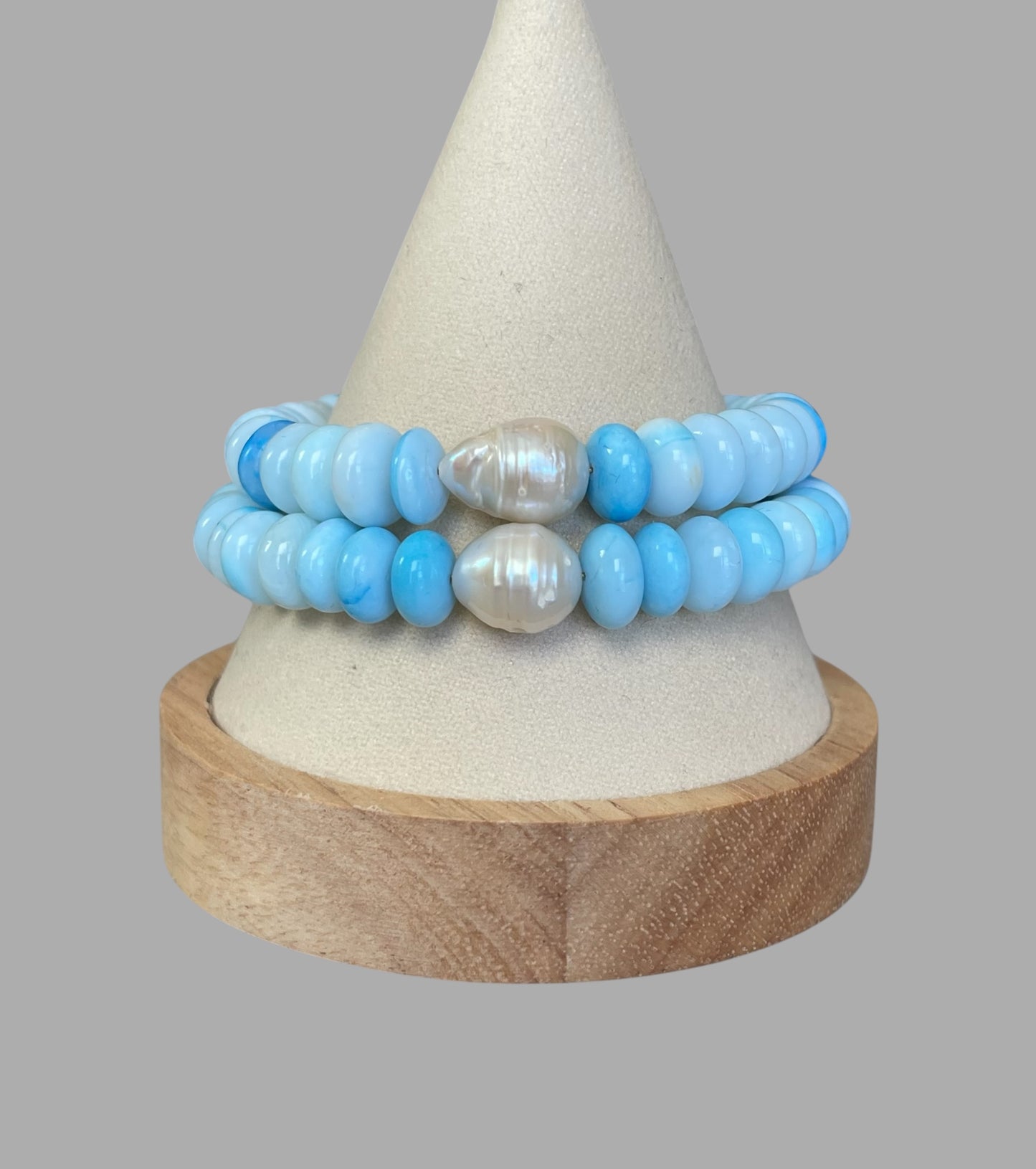 Robin’s Egg Opal Bracelet: Robin’s egg blue Opals with a Baroque Pearl center Gold clasp