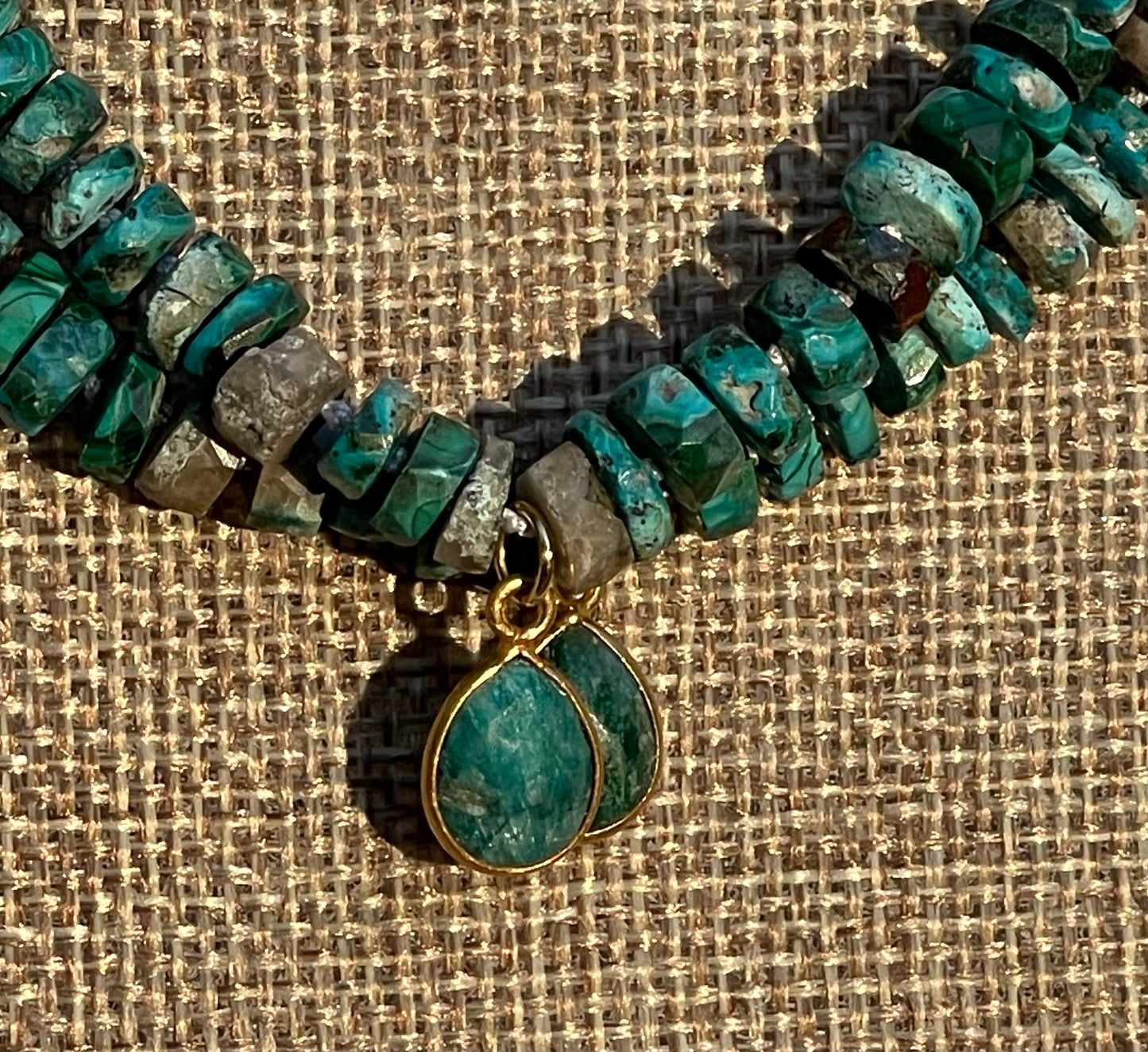 Tibetan Tides Necklace: Faceted Tibetan Turquoise Handknotted on silk with an Emerald teardrop pendant
