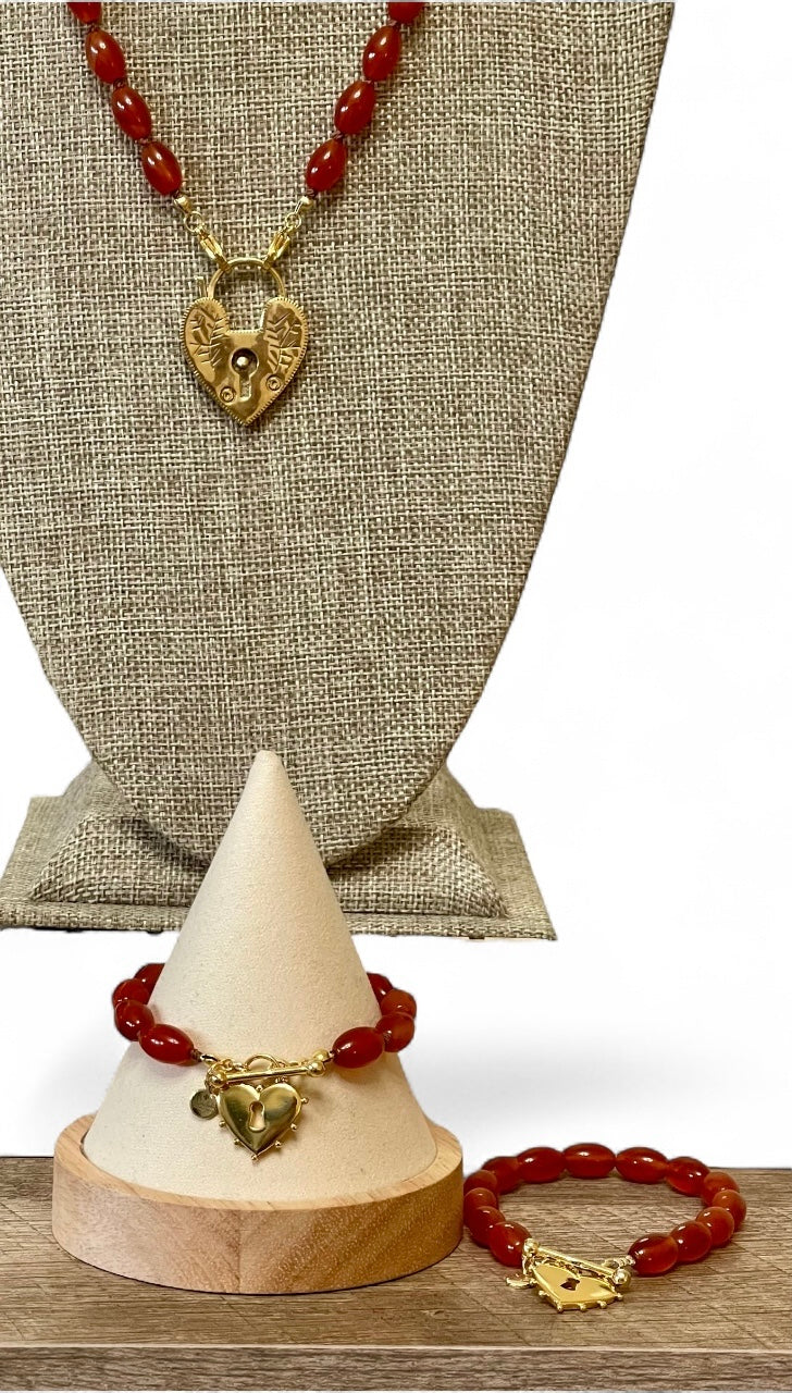 Carnelian Heartlock Necklace: Carnelian gemstone oval beads handknotted on warm brown silk GF heart pendant