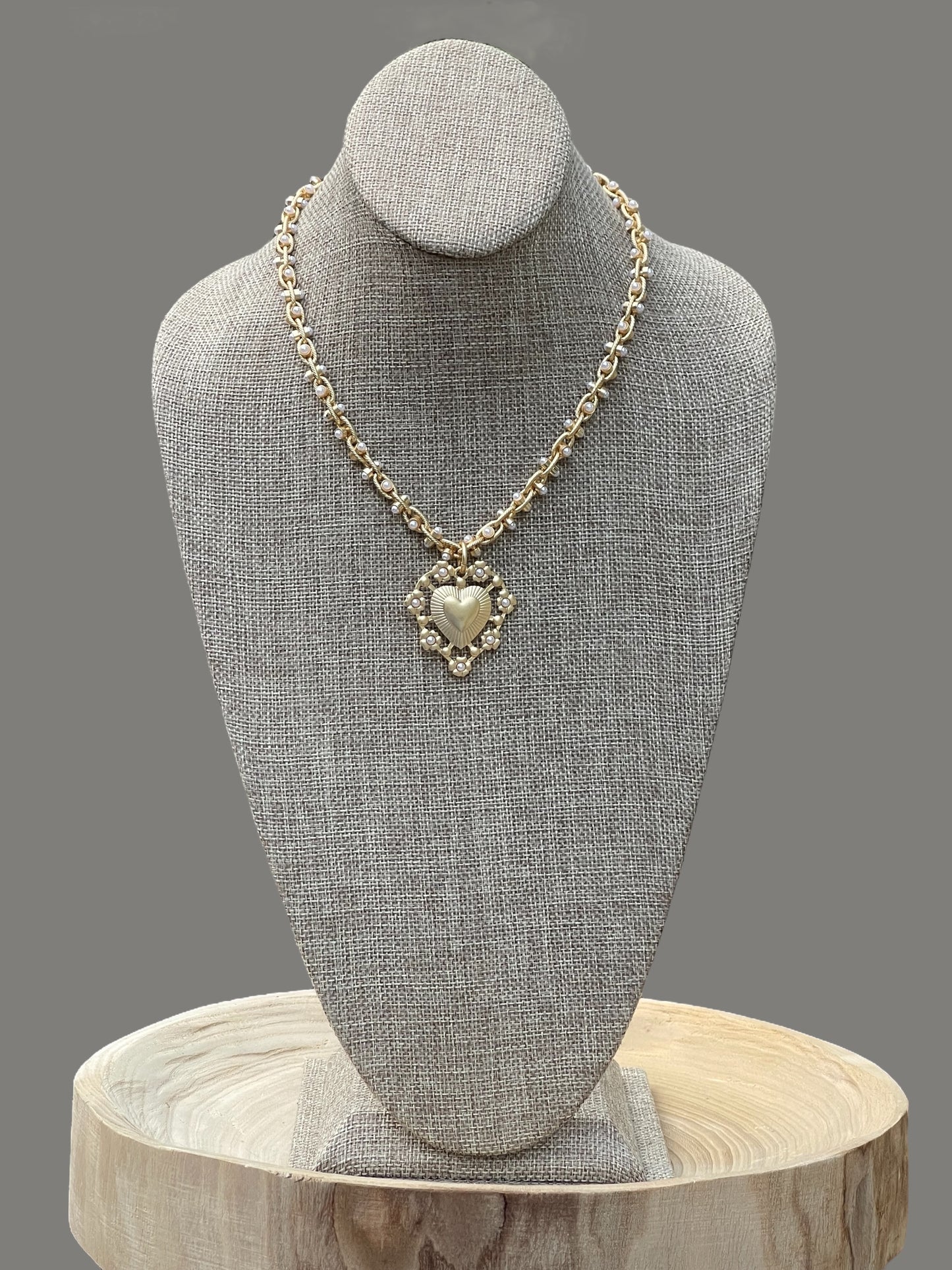 Bold Bijoux in Gold Necklace: Matte gold throughout Tiny pearls Statement heart