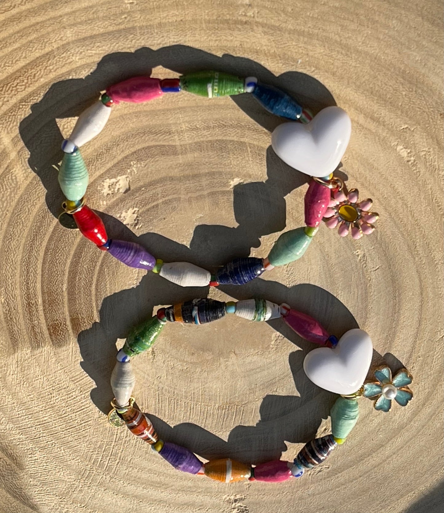 Kindred Colors Bracelet: Recycled paper bicone shaped beads, glass spacer beads, shiny white heart and flower charm