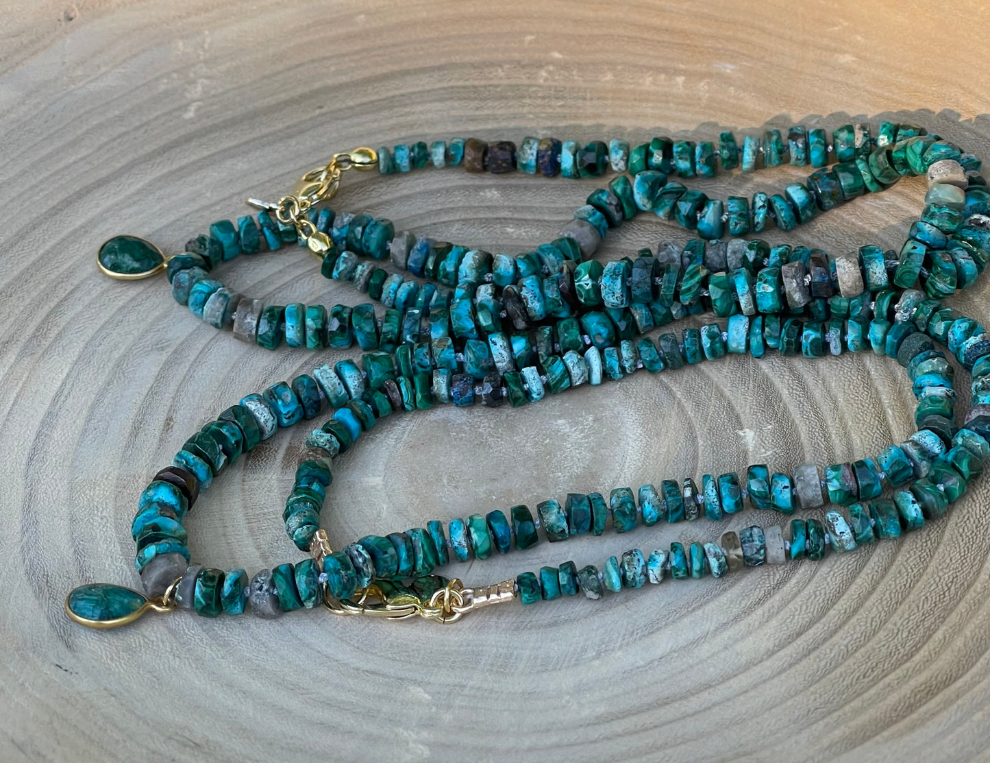 Tibetan Tides Necklace: Faceted Tibetan Turquoise Handknotted on silk with an Emerald teardrop pendant