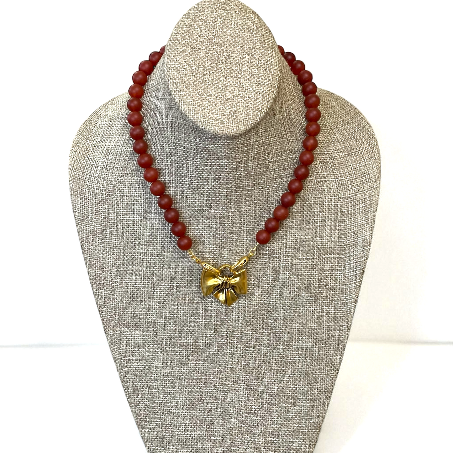 Matte Carnelian Bow Necklace: Matte Carnelian gemstone beads Antiqued gold bow pendant