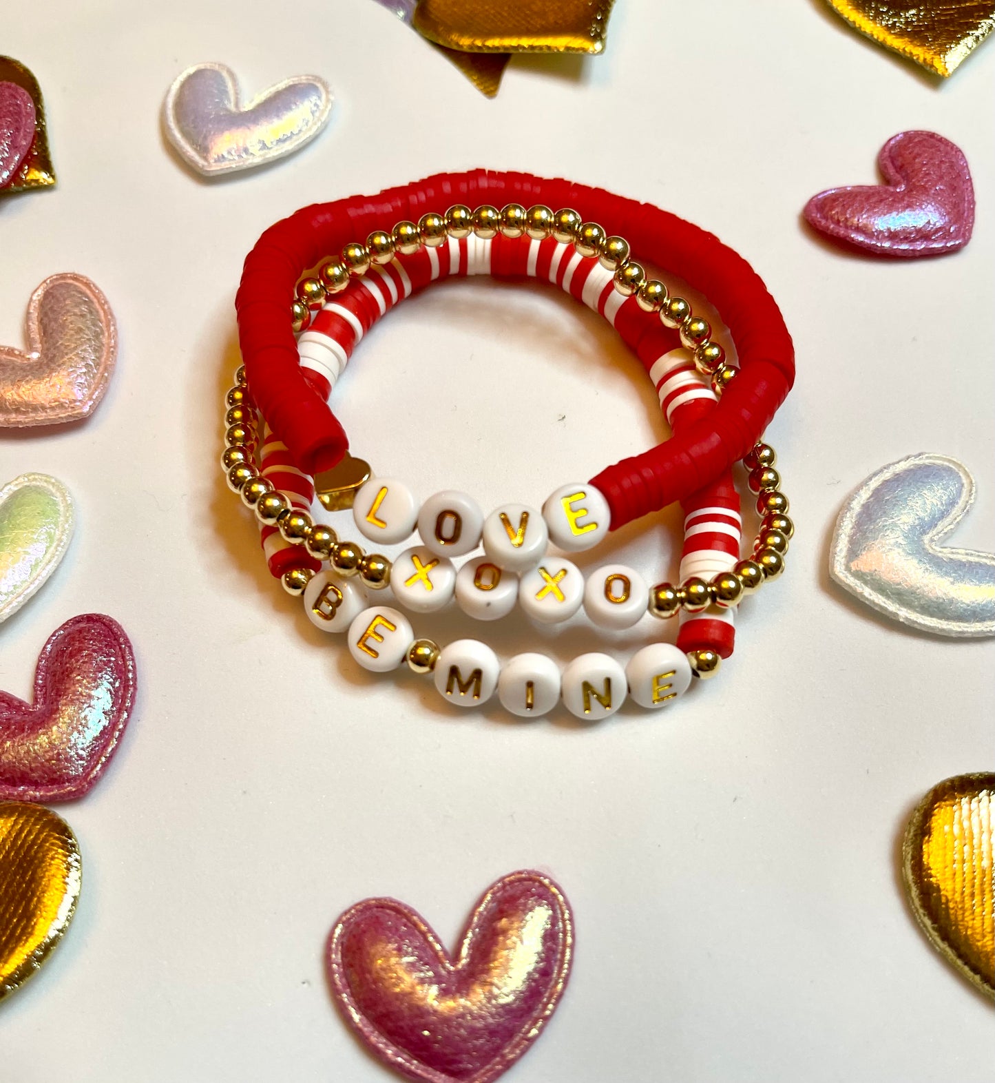 Love Stack 2: Red&white clay bead stretch bracelets and a gold plated bead bracelet, all with letter beads