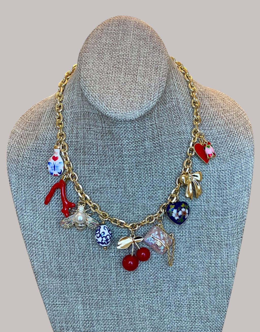 The Jackie Necklace: Tarnish resistant gold chain with various charms in a red pink & blue theme