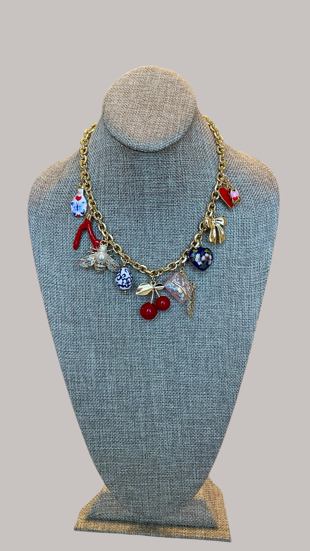 The Jackie Necklace: Tarnish resistant gold chain with various charms in a red pink & blue theme