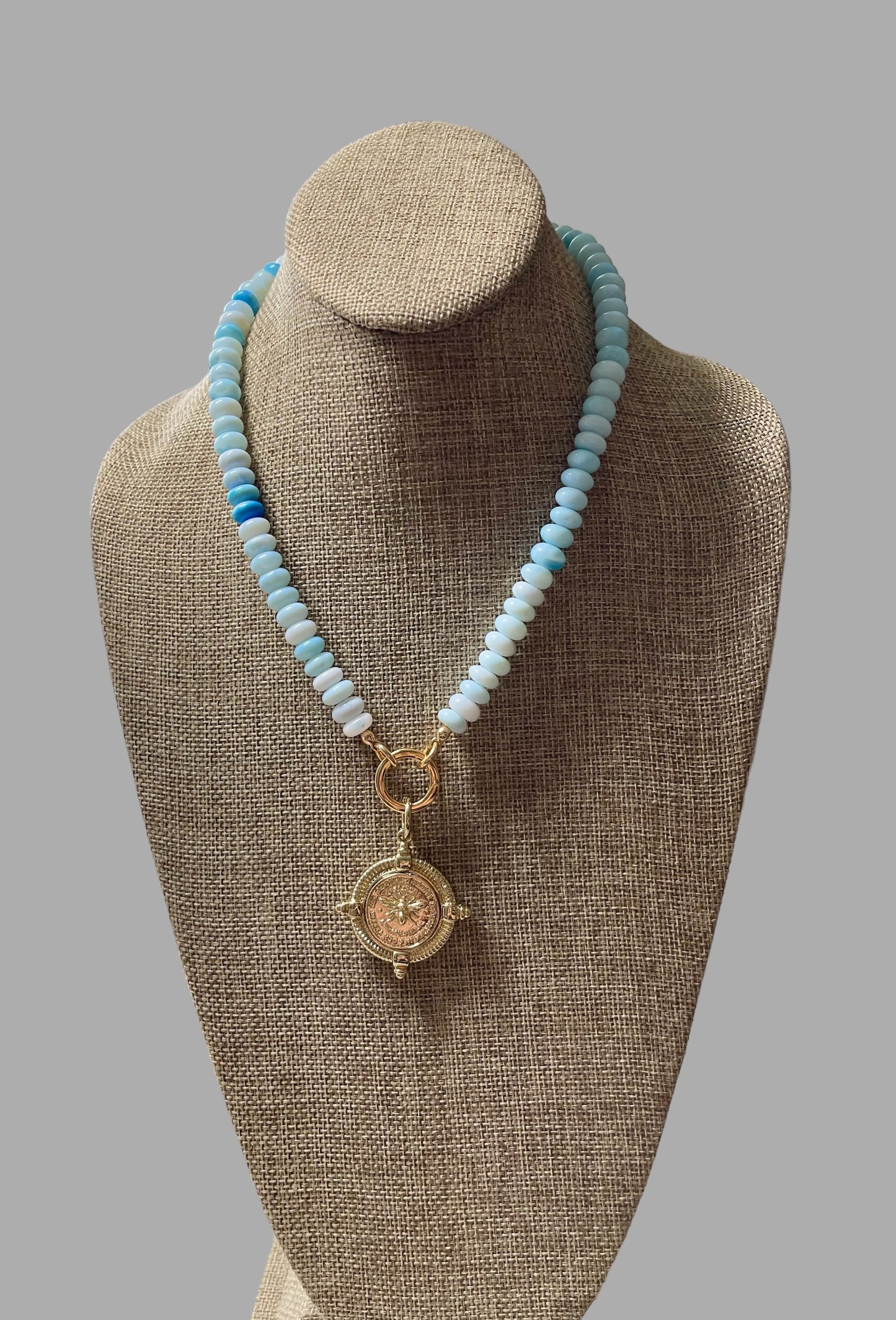 The Skylar Necklace: Sky Blue Opals with a Gold Circle Clasp and French Bee Coin Style Charm