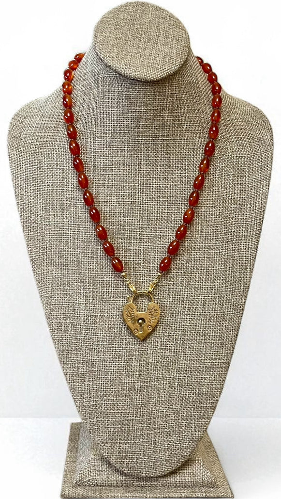 Carnelian Heartlock Necklace: Carnelian gemstone oval beads handknotted on warm brown silk GF heart pendant