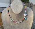 Kindred Colors Necklace: Unique beads handmade in Uganda from recycled paper, glass & acrylic accent beads and a brass flower charm