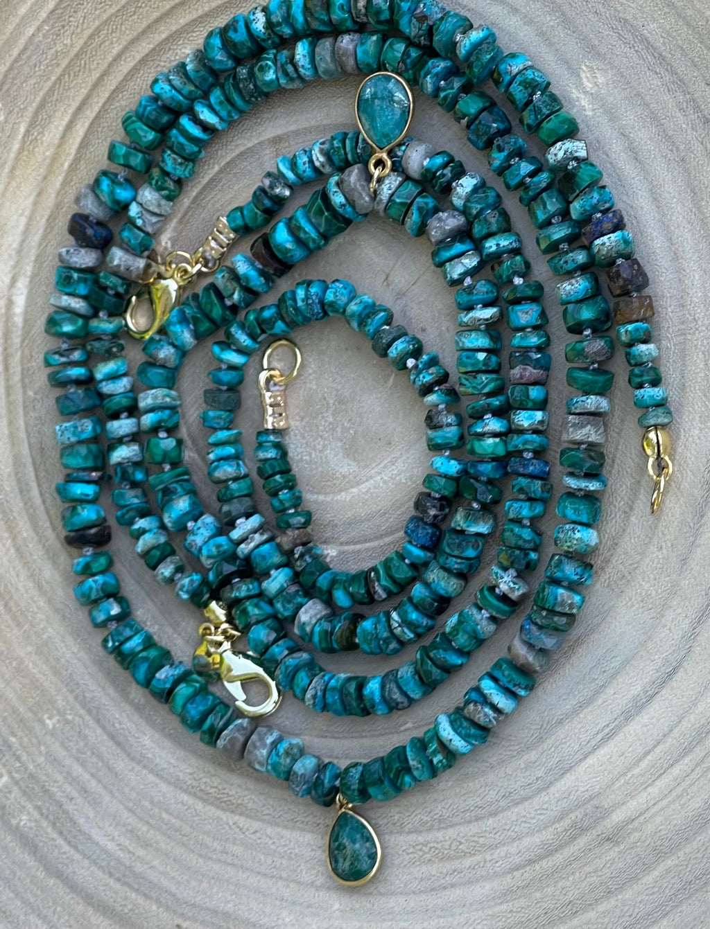 Tibetan Tides Necklace: Faceted Tibetan Turquoise Handknotted on silk with an Emerald teardrop pendant