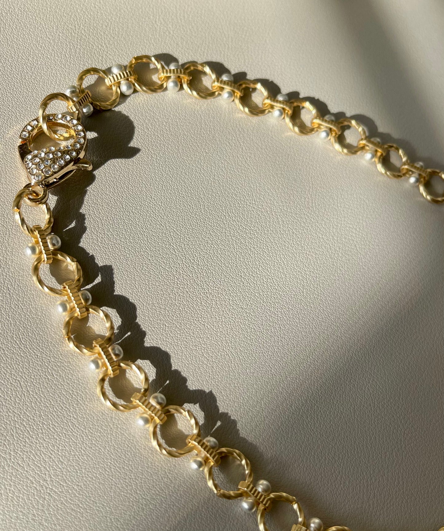 Heather Necklace: Brushed gold circle chain with brushed silver accents and oversized pavé clasp