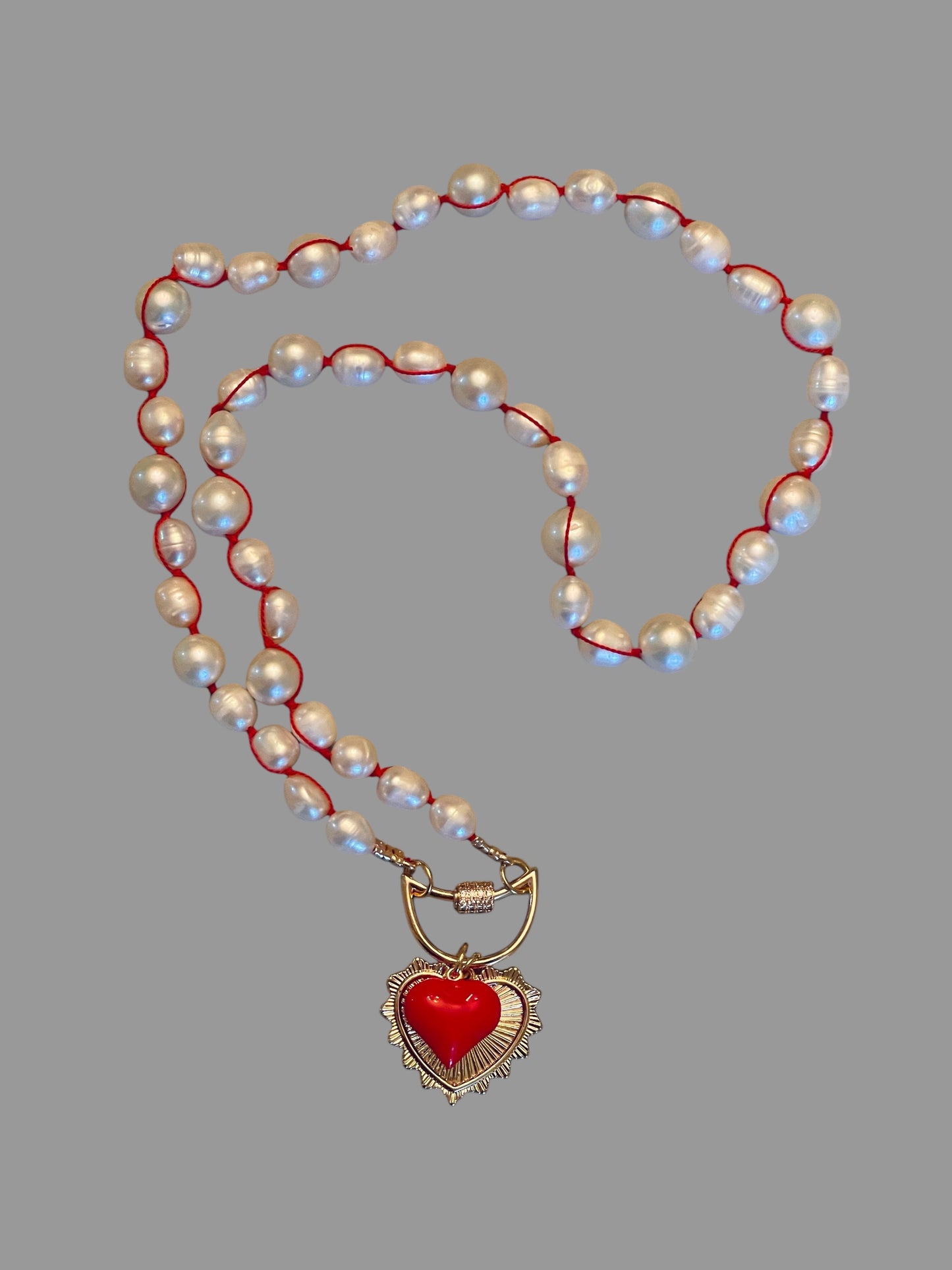 The Heartstrings Necklace: Luminous high quality freshwater pearls hand knotted on red silk w/ gold and red enameled heart charms, pavé accented clasp/charm holder OOAK