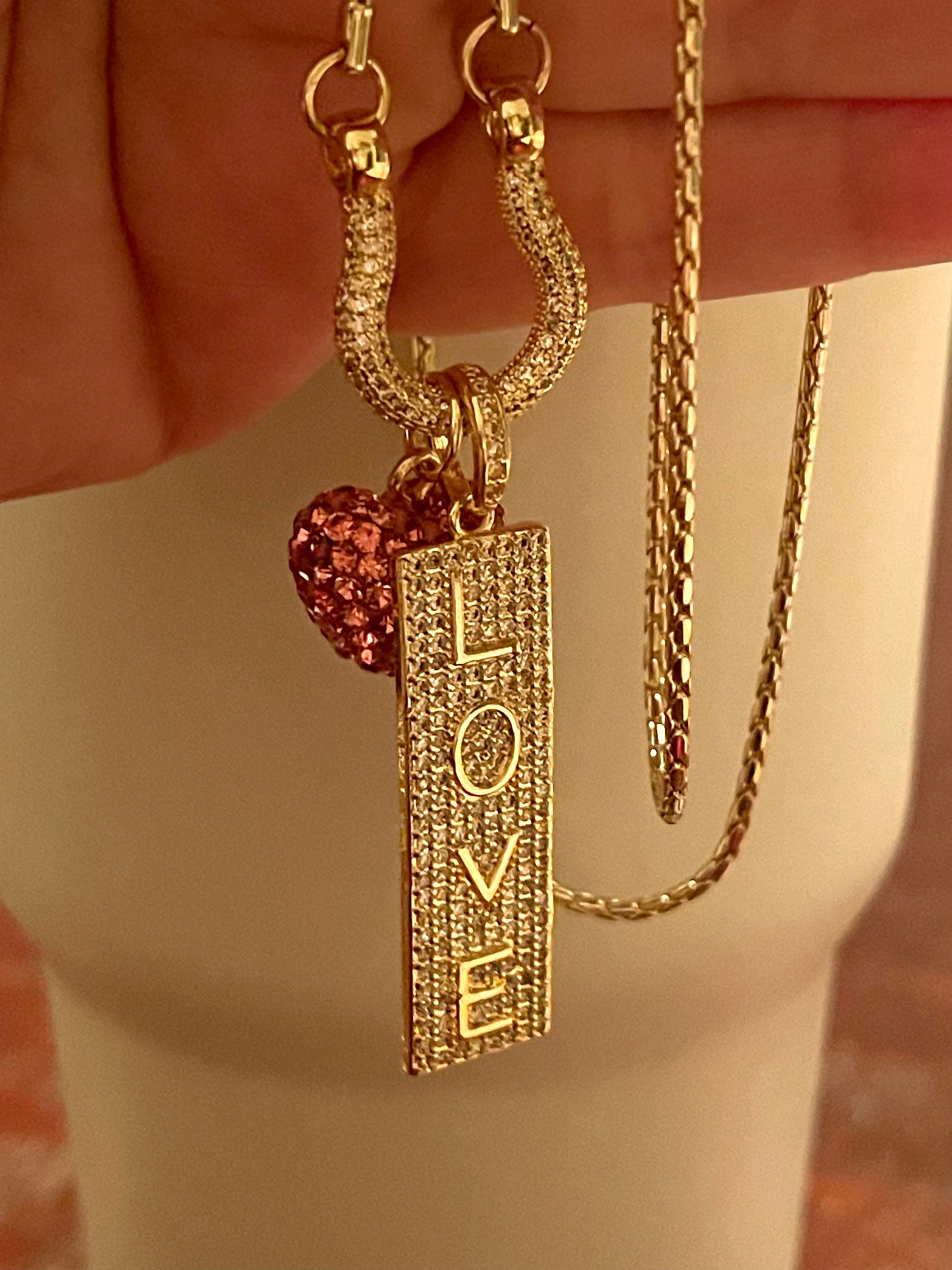 OOAK Stirrup of Love Charm Holder Necklace: Cobra chain with a pavé stirrup holding 2 charms- A pink sparkle 3D heart and a pavé LOVE sign