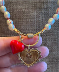 The Heartstrings Necklace: Luminous high quality freshwater pearls hand knotted on red silk w/ gold and red enameled heart charms, pavé accented clasp/charm holder OOAK