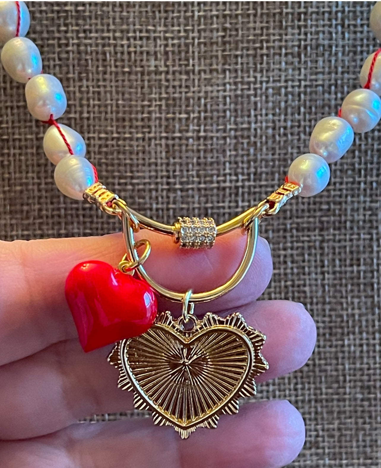 The Heartstrings Necklace: Luminous high quality freshwater pearls hand knotted on red silk w/ gold and red enameled heart charms, pavé accented clasp/charm holder OOAK