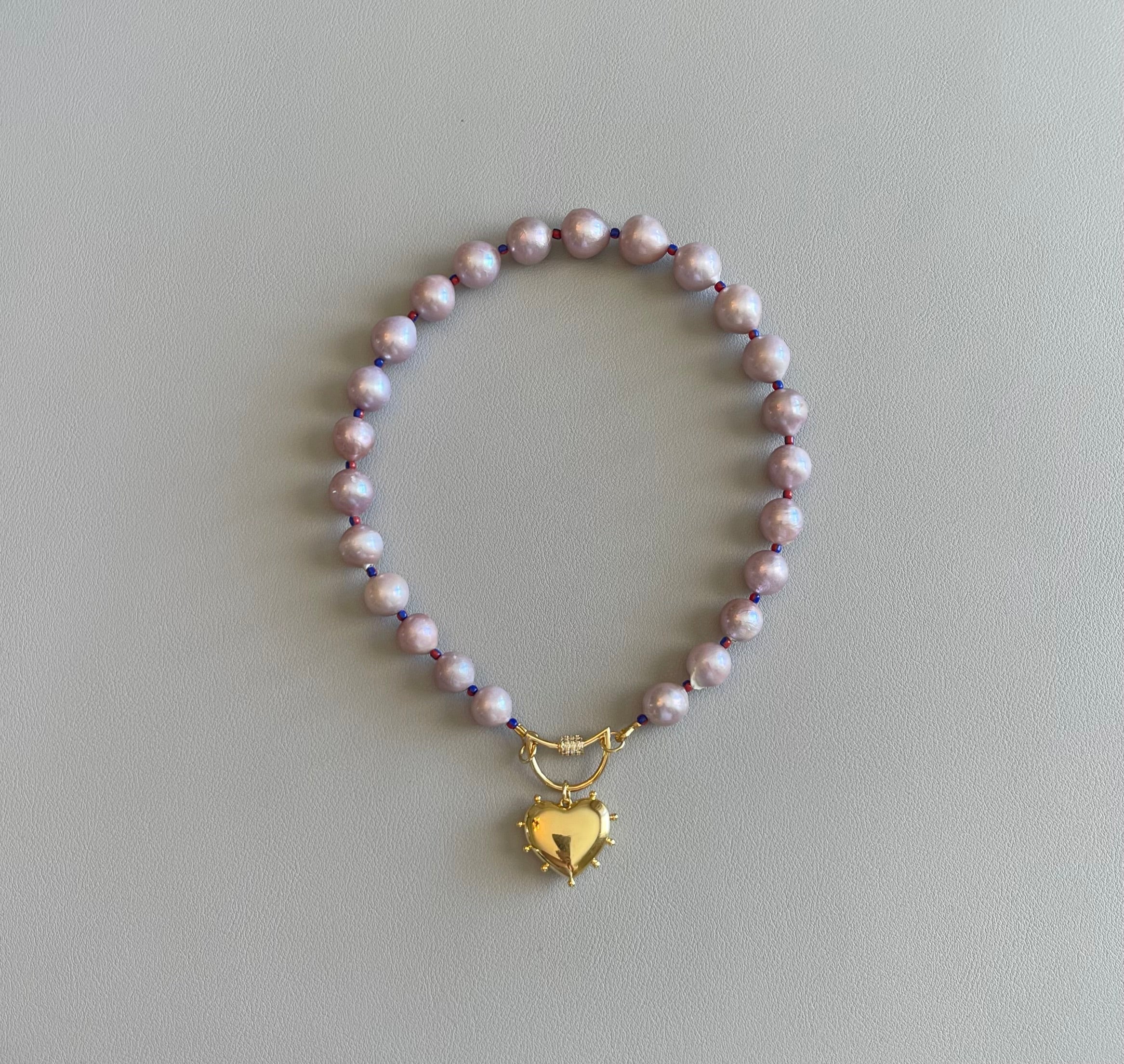 The Yves Necklace: Lavender Edison Pearls w/glass spacers, a gold crescent clasp holding a heart pendant OOAK