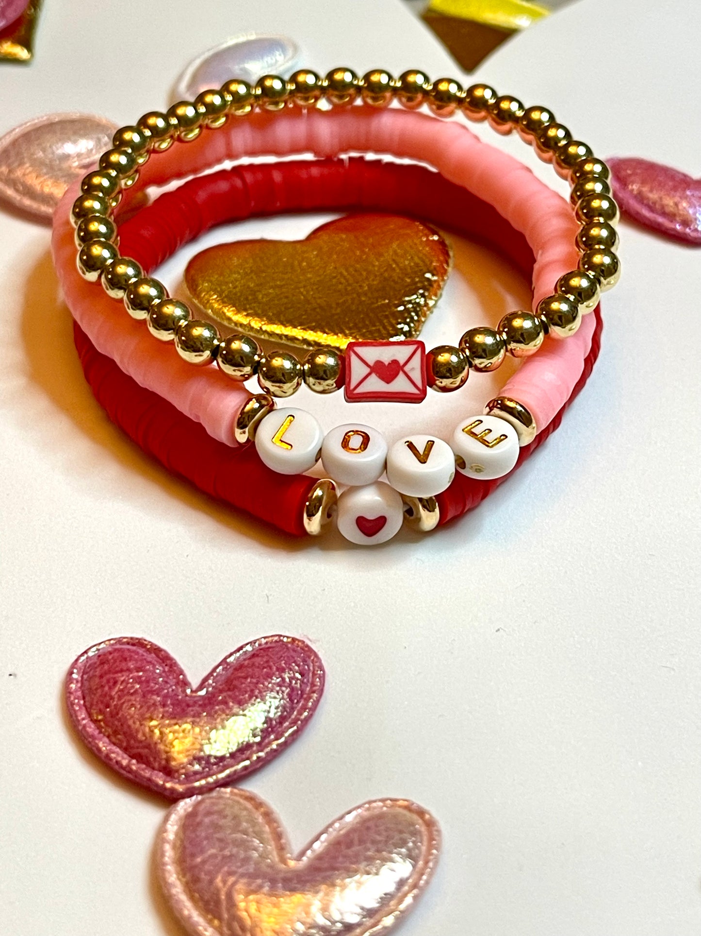 Love Stack 1: Red&Pink clay bead bracelets with acrylic letter beads and a gold plated bead bracelet featuring a love letter charm