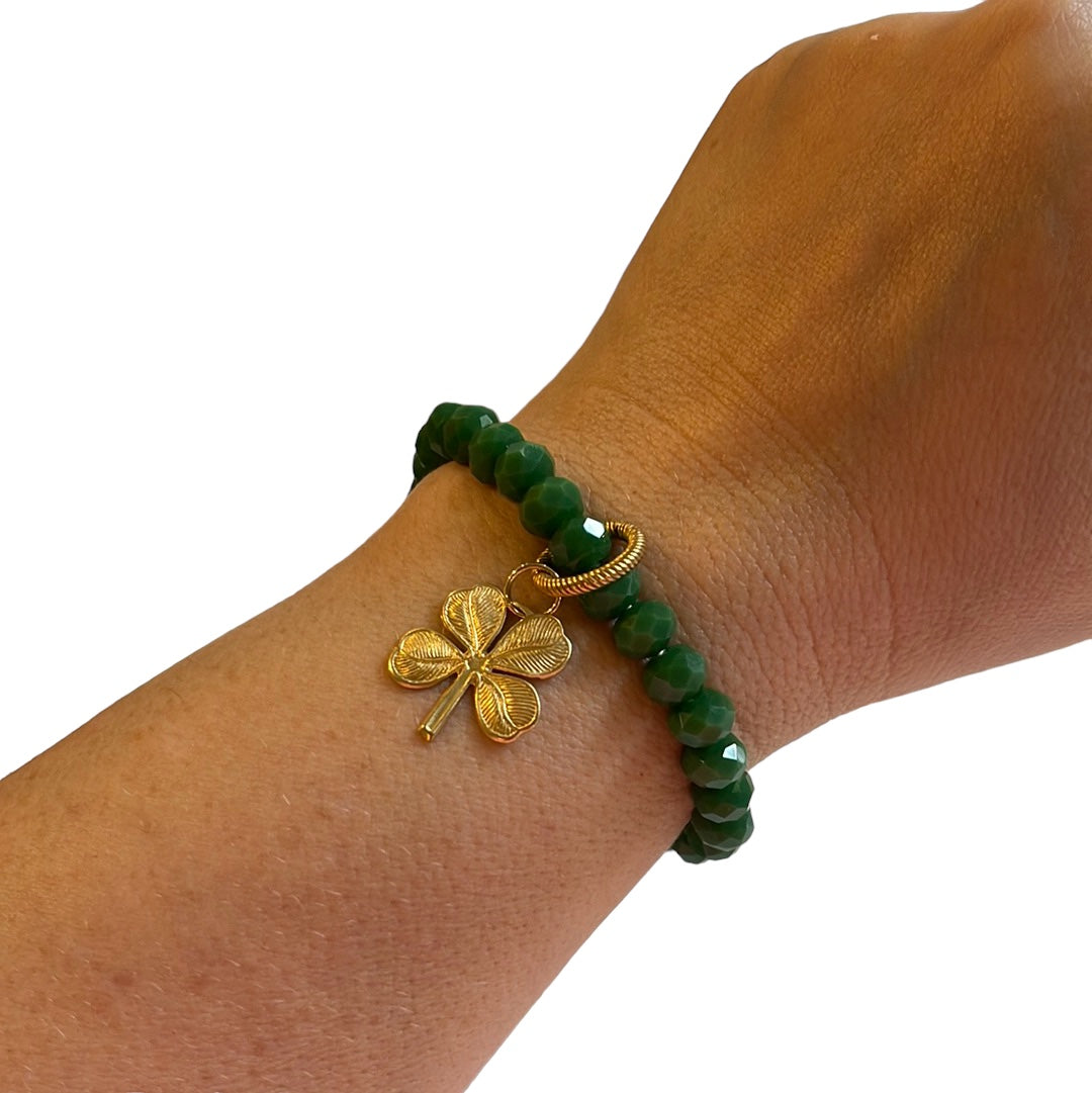 Lucky Charm Bracelet: Gorgeous tone of green in a faceted acrylic beaded stretch bracelet with a solid brass charm