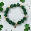 Green Glass and Gold Shamrock bracelet: A stretch bracelet made with glass carved beads and gold filled brass accent beads FREE SHIPPING!