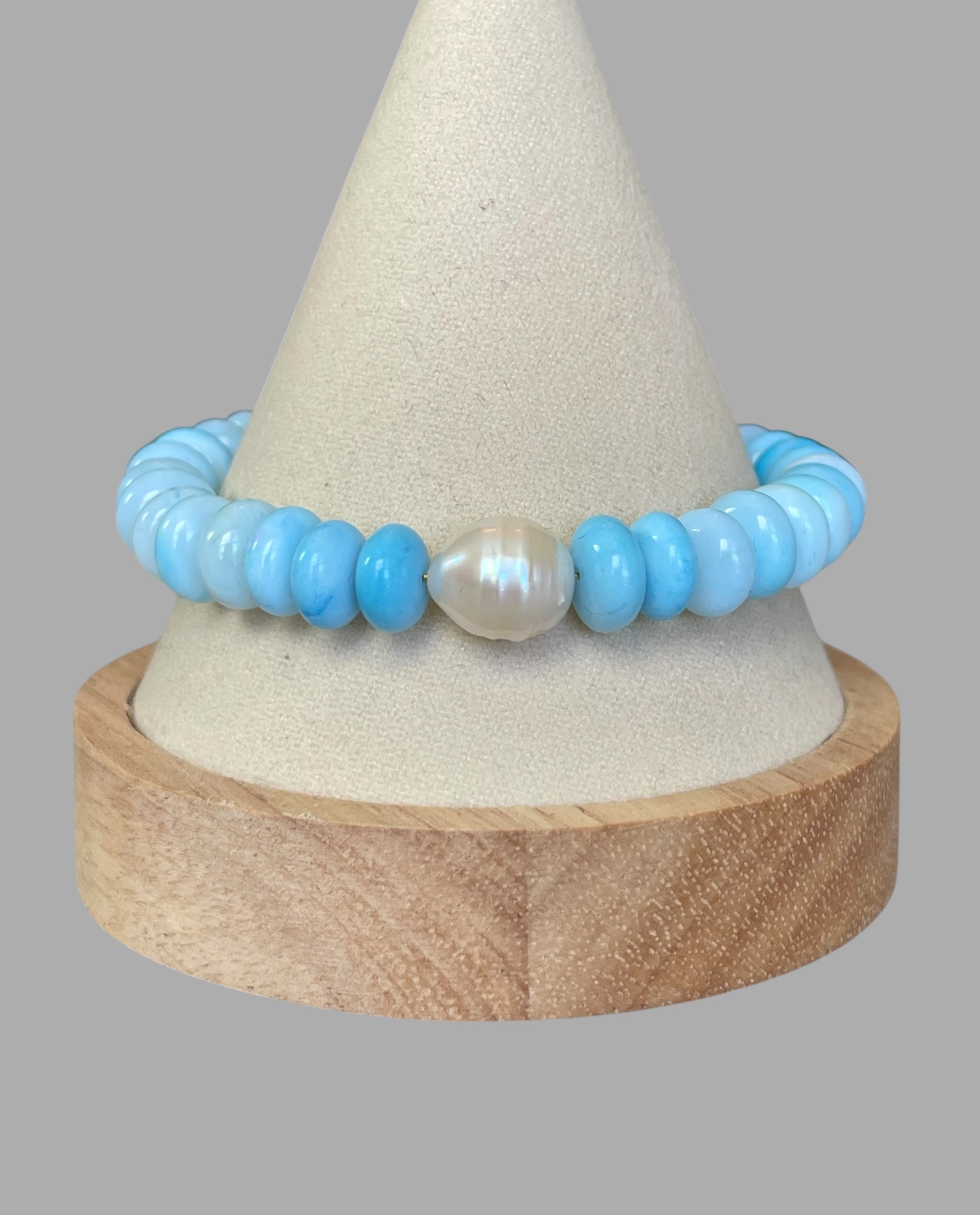Robin’s Egg Opal Bracelet: Robin’s egg blue Opals with a Baroque Pearl center Gold clasp