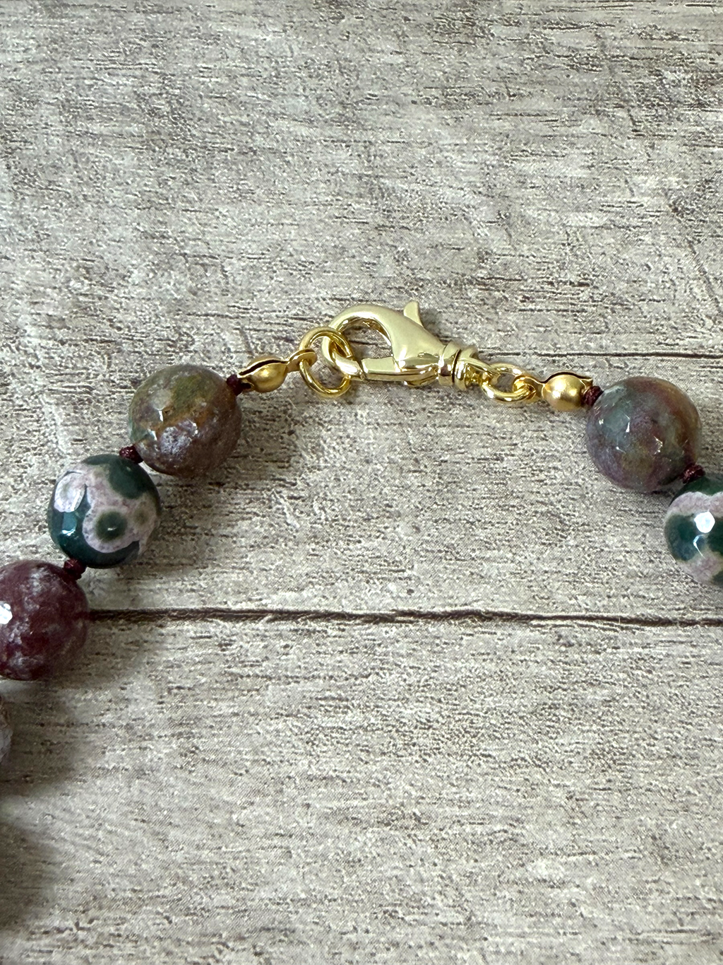 Heart & Soul Necklace: Faceted Ocean Jasper handknotted on deep burgundy. Removable gold heart