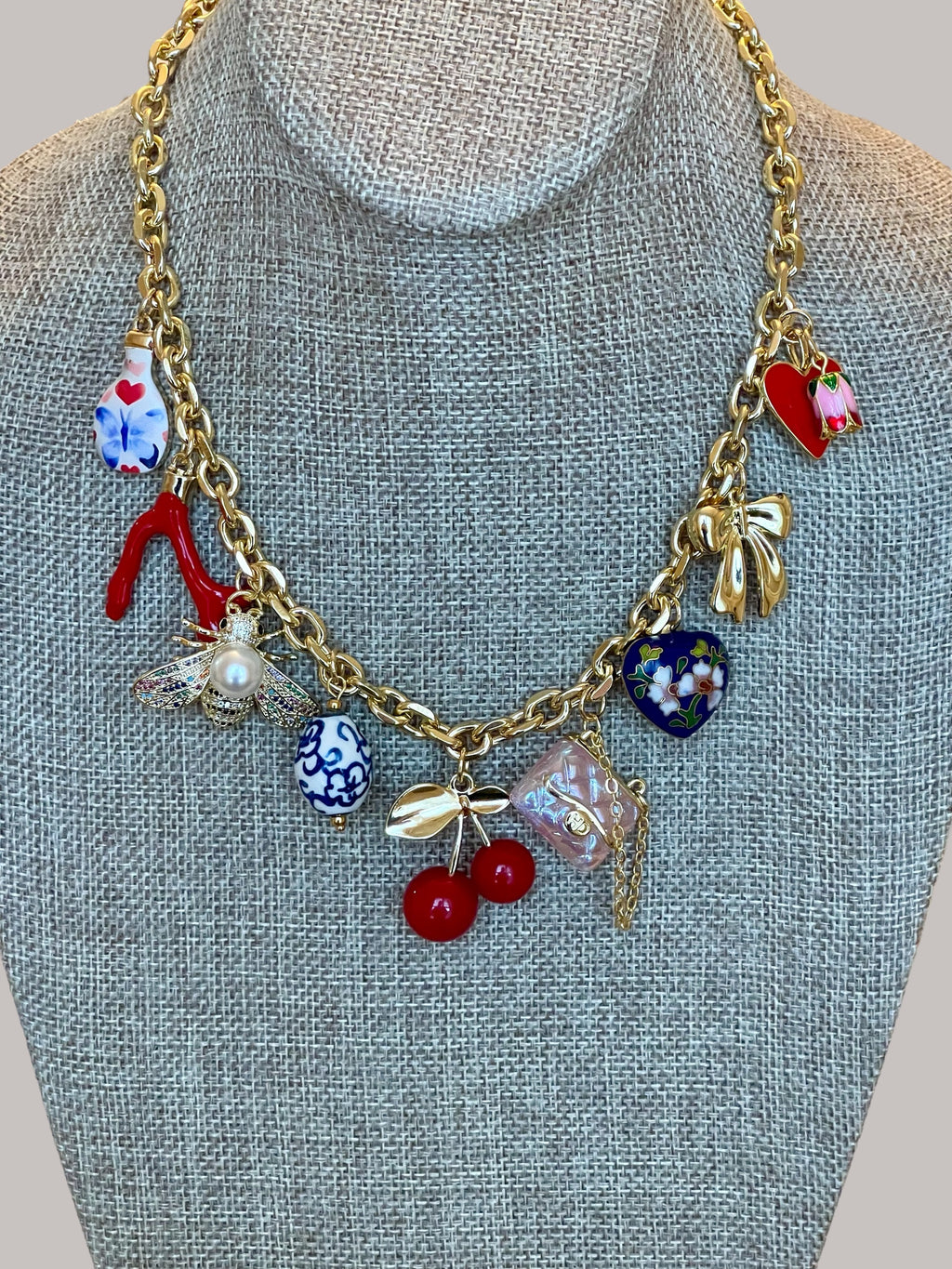 The Jackie Necklace: Tarnish resistant gold chain with various charms in a red pink & blue theme