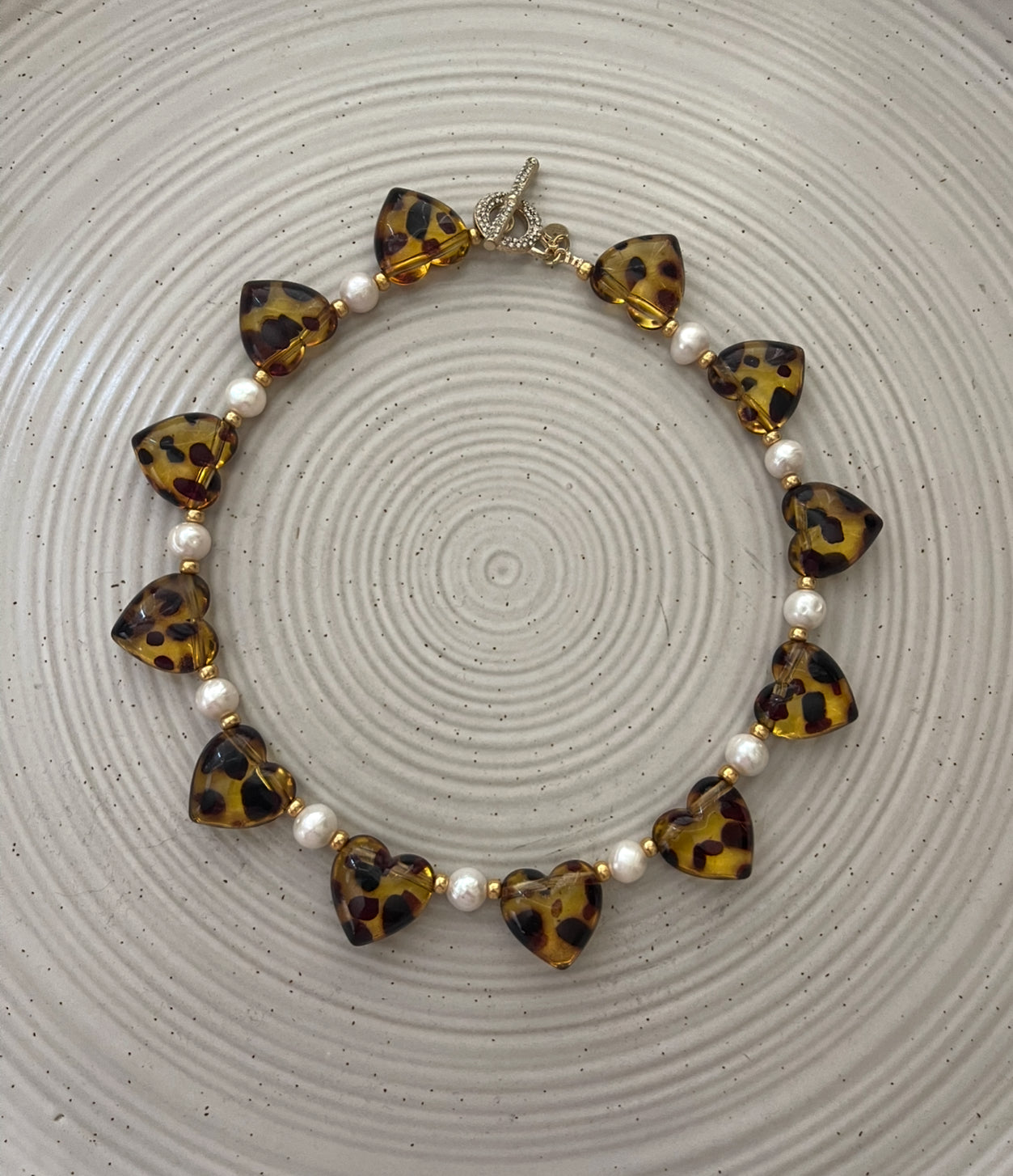 Leopard Love Necklace: Acrylic Leopard Print hearts with gold glass accent beads and Freshwater Pearls Gold Pavé toggle clasp