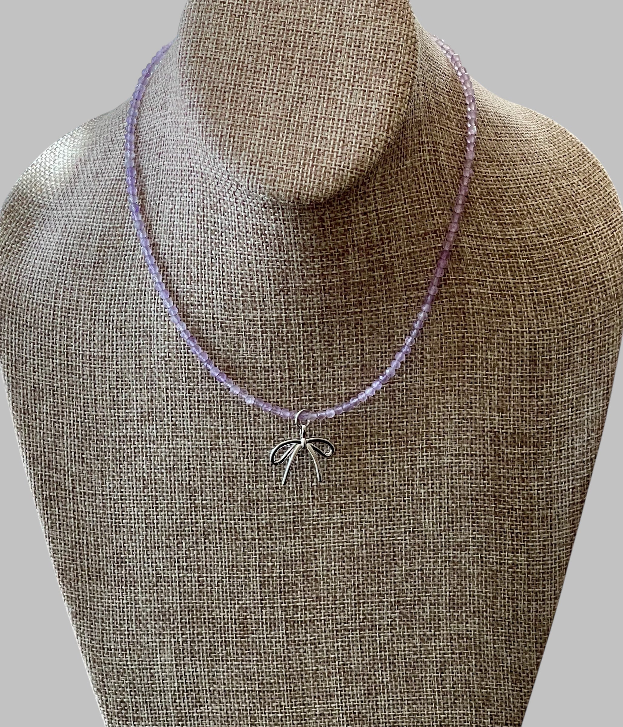 The Amethyst Skinny: Faceted Amethyst gemstones with a bow charm in Gold or Silver
