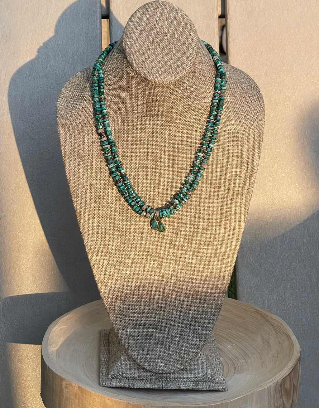 Tibetan Tides Necklace: Faceted Tibetan Turquoise Handknotted on silk with an Emerald teardrop pendant