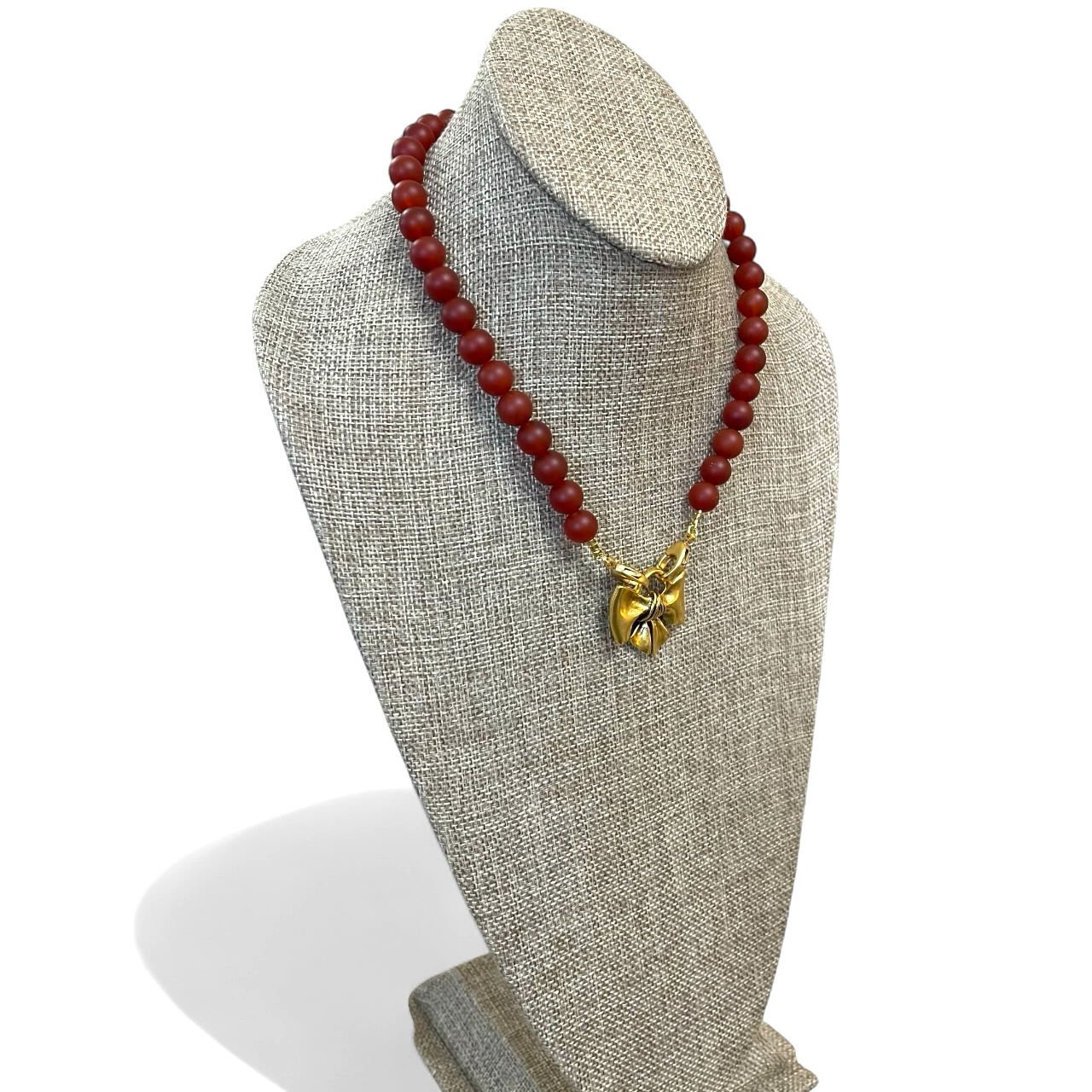 Matte Carnelian Bow Necklace: Matte Carnelian gemstone beads Antiqued gold bow pendant