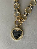 Heart On Your Sleeve Necklace: Brushed gold chain with gunmetal accents, a push gate circle clasp and pavé heart pendant
