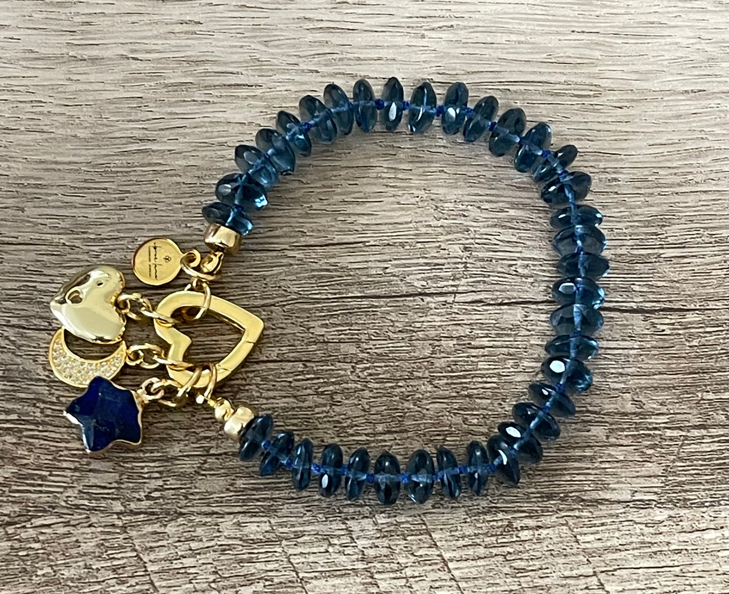 London Blue Bracelet: Hand knotted London Blue Topaz faceted gemstone beads Gold heart clasp with Lapis Lazuli star, Pavé moon and CZ accent heart charms OOAK
