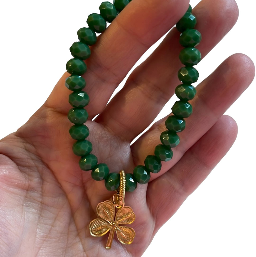 Lucky Charm Bracelet: Gorgeous tone of green in a faceted acrylic beaded stretch bracelet with a solid brass charm